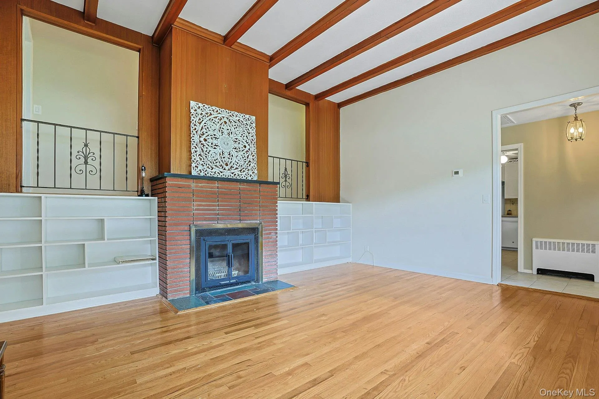 Large livingroom with beamed ceilings, hardwood flooring and built in shelving Large livingroom with beamed ceilings, hardwood flooring and built in shelving