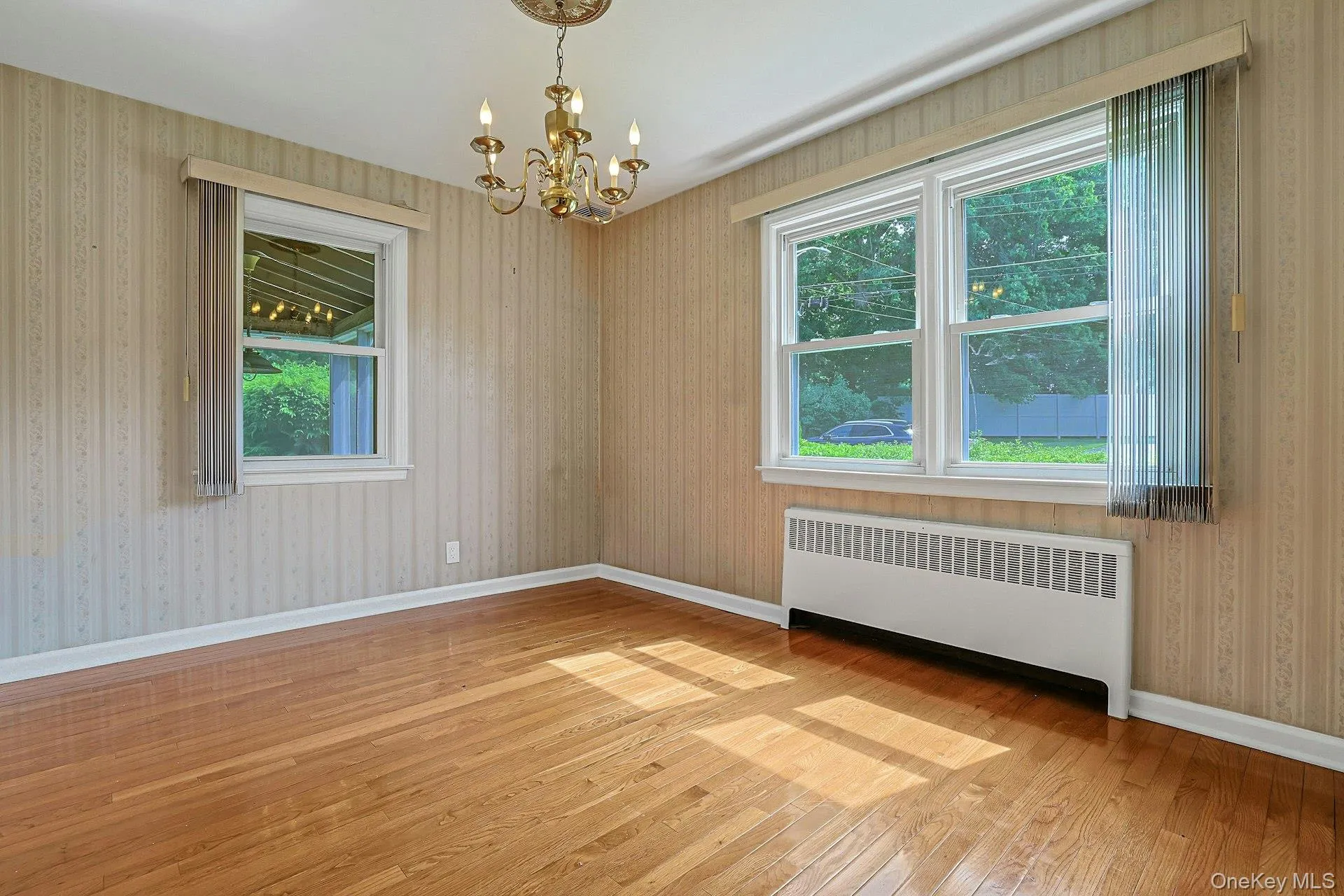 dining room with hardwood floors, chandelier and lots of natural light dining room with hardwood floors, chandelier and lots of natural light