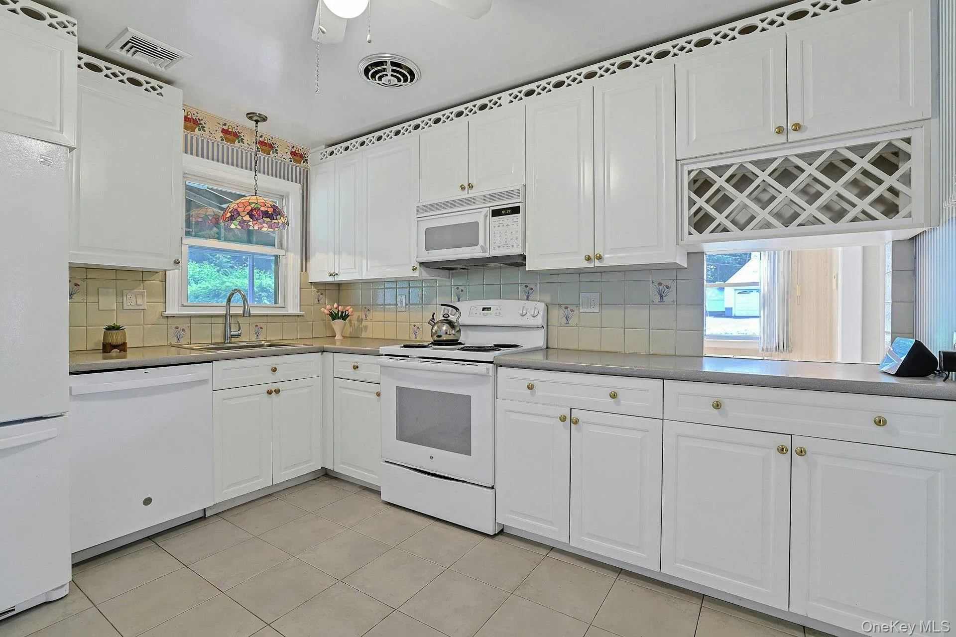 All white kitchen with plenty of cabinet storage All white kitchen with plenty of cabinet storage