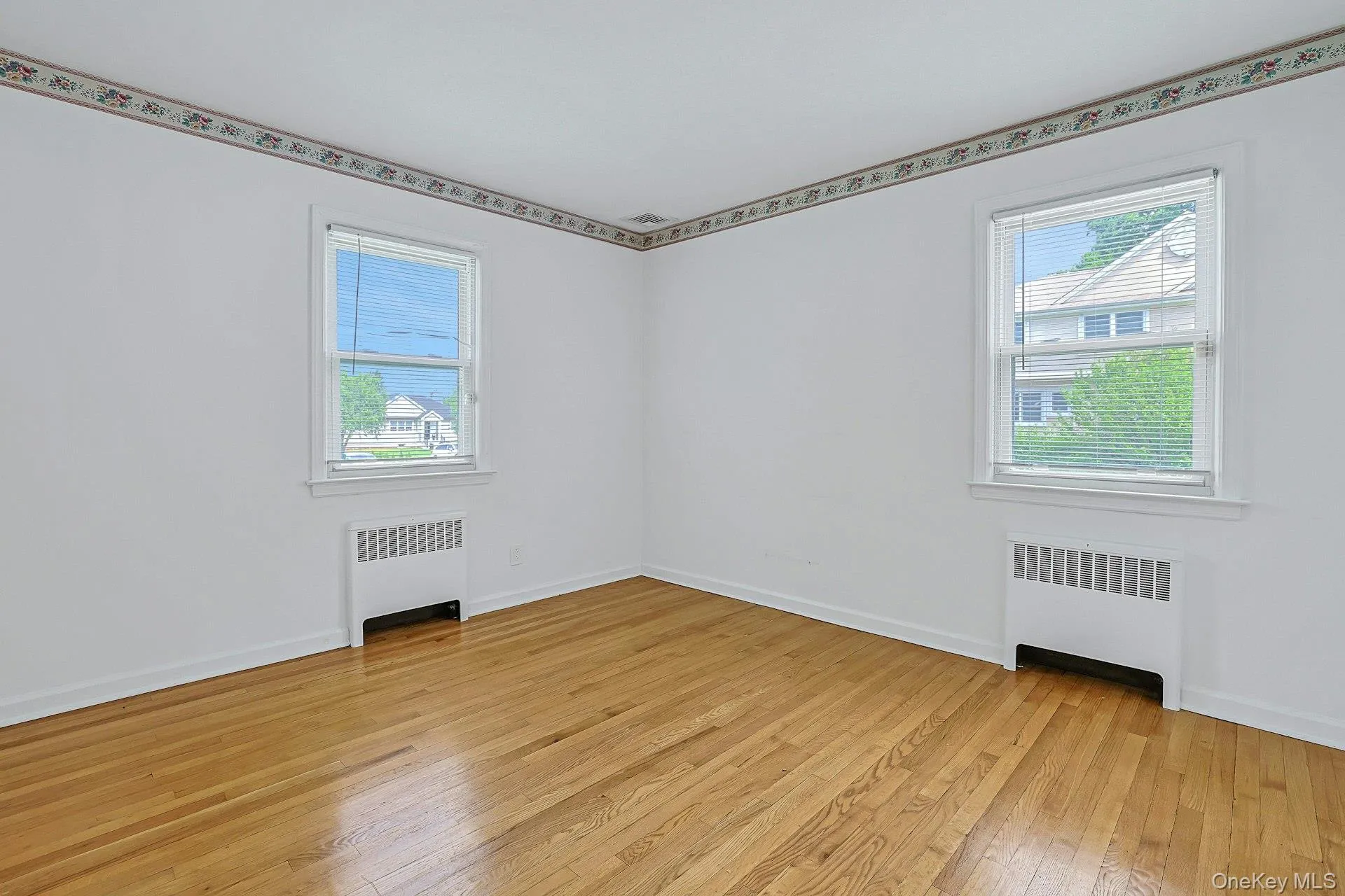 Bedroom #3 with plenty of natural light and hardwood flooring Bedroom #3 with plenty of natural light and hardwood flooring