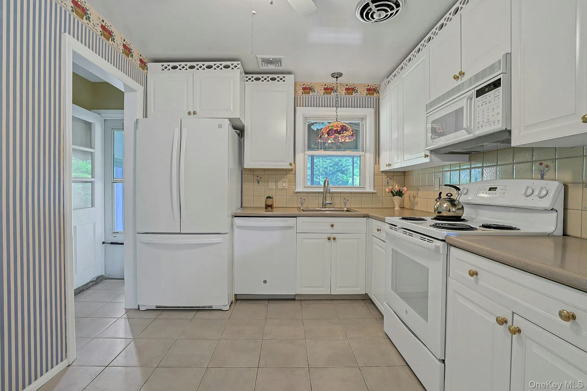 another angle of the kitchen with a door to the screened in porch another angle of the kitchen with a door to the screened in porch