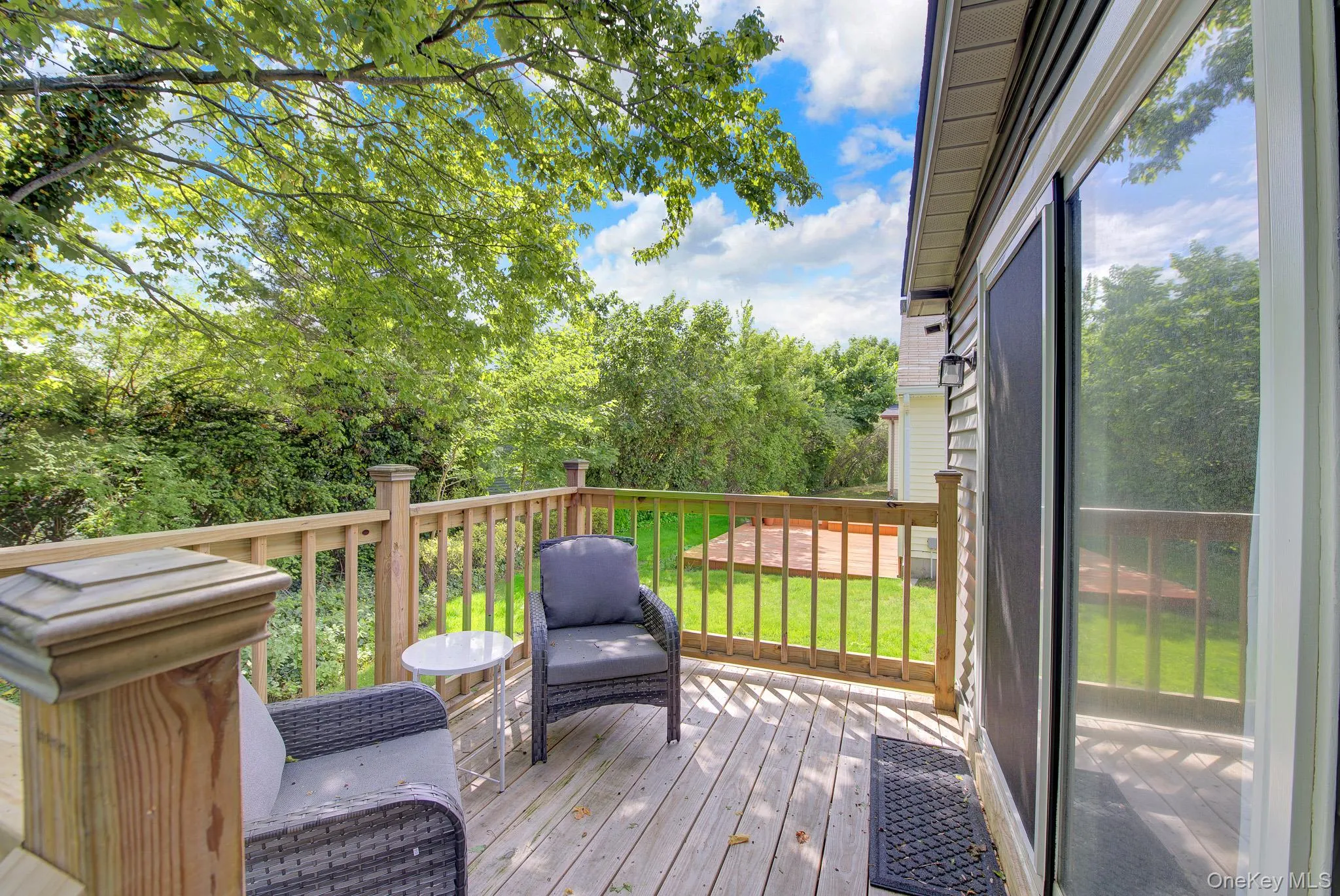 Wood-finish deck with a full-pane sliding glass door Wood-finish deck with a full-pane sliding glass door