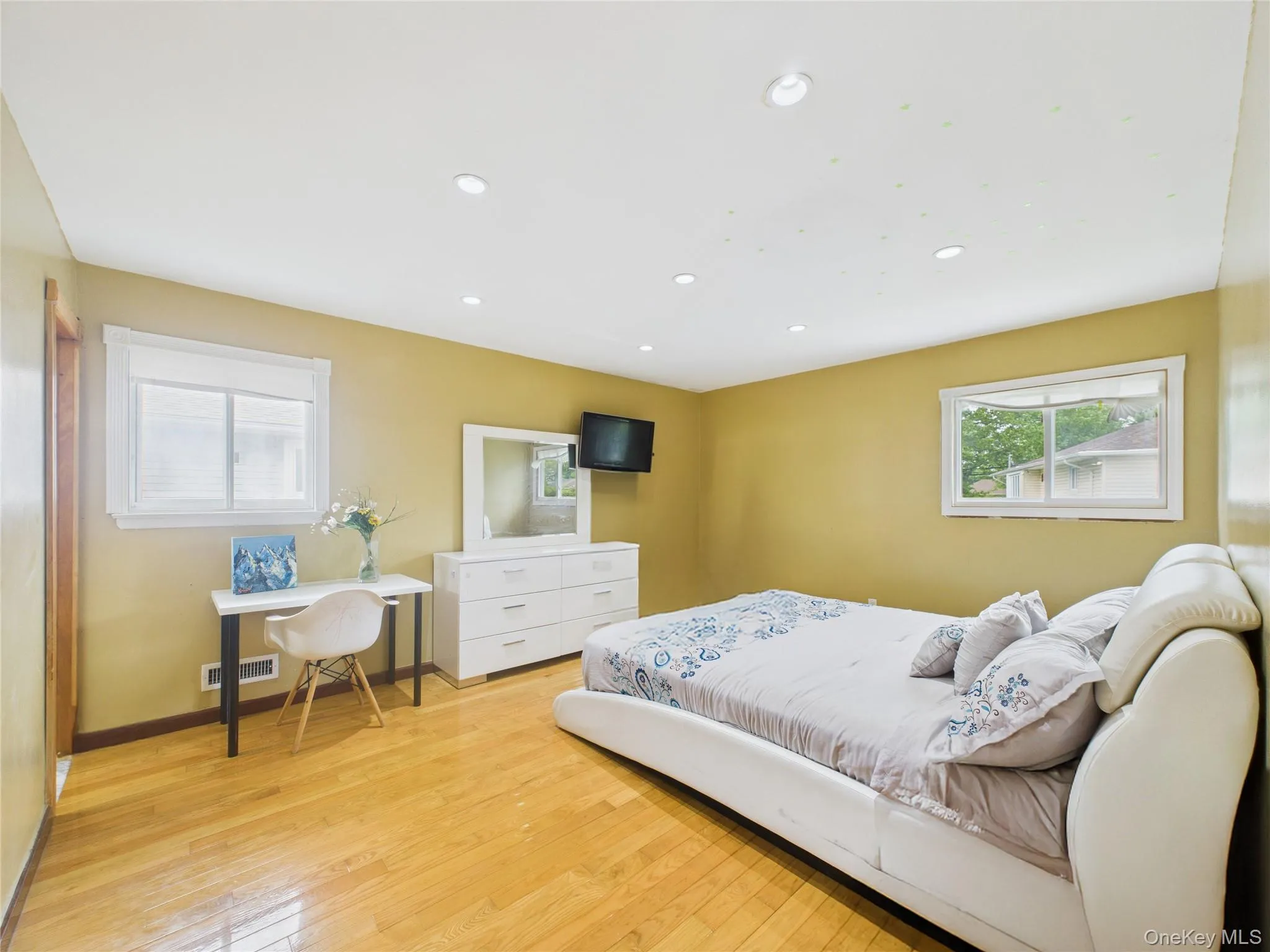 Bedroom featuring recessed lighting, light wood-type flooring, and baseboards Bedroom featuring recessed lighting, light wood-type flooring, and baseboards