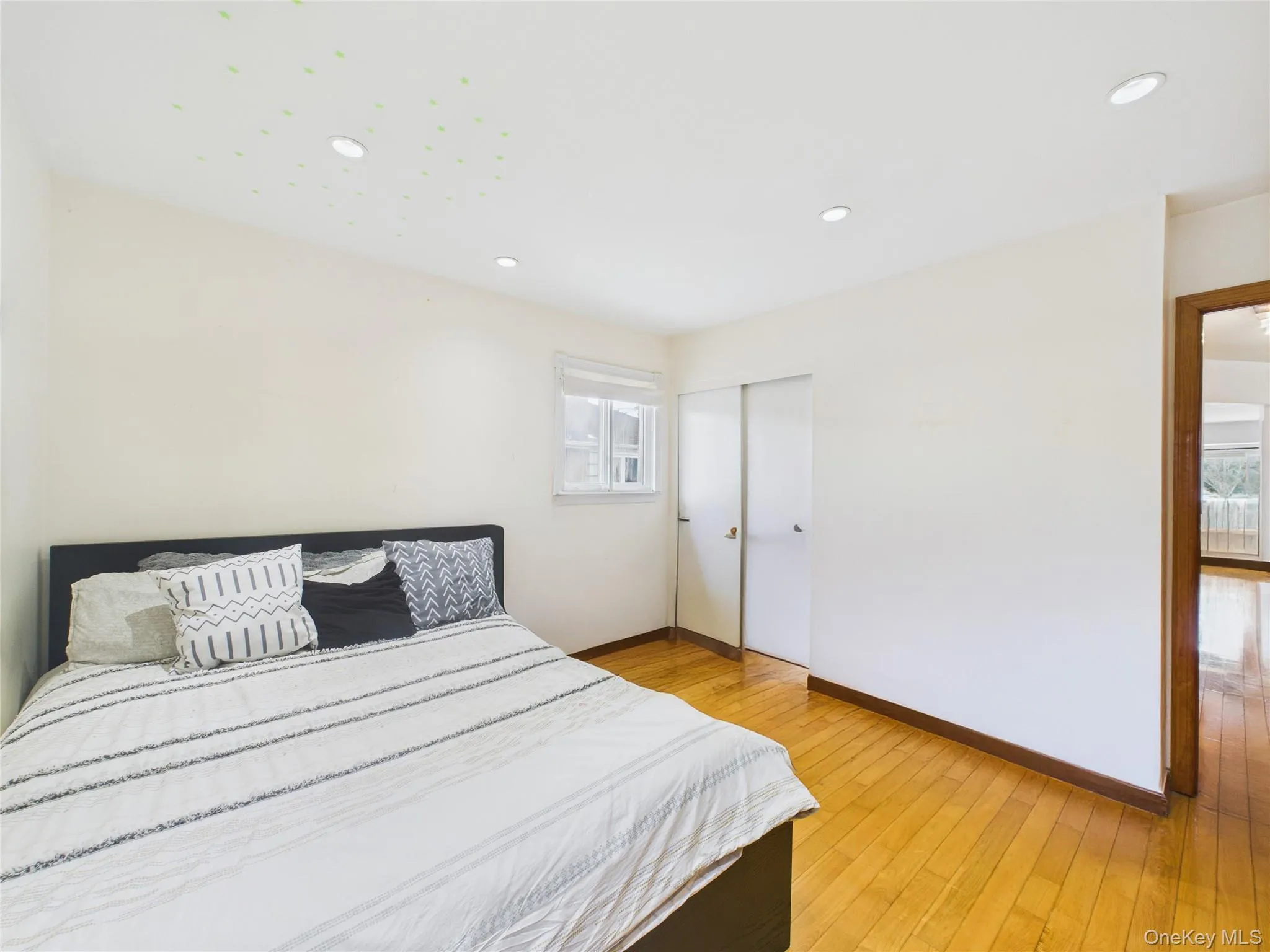 Bedroom with baseboards, a closet, light wood-style flooring, and recessed lighting Bedroom with baseboards, a closet, light wood-style flooring, and recessed lighting