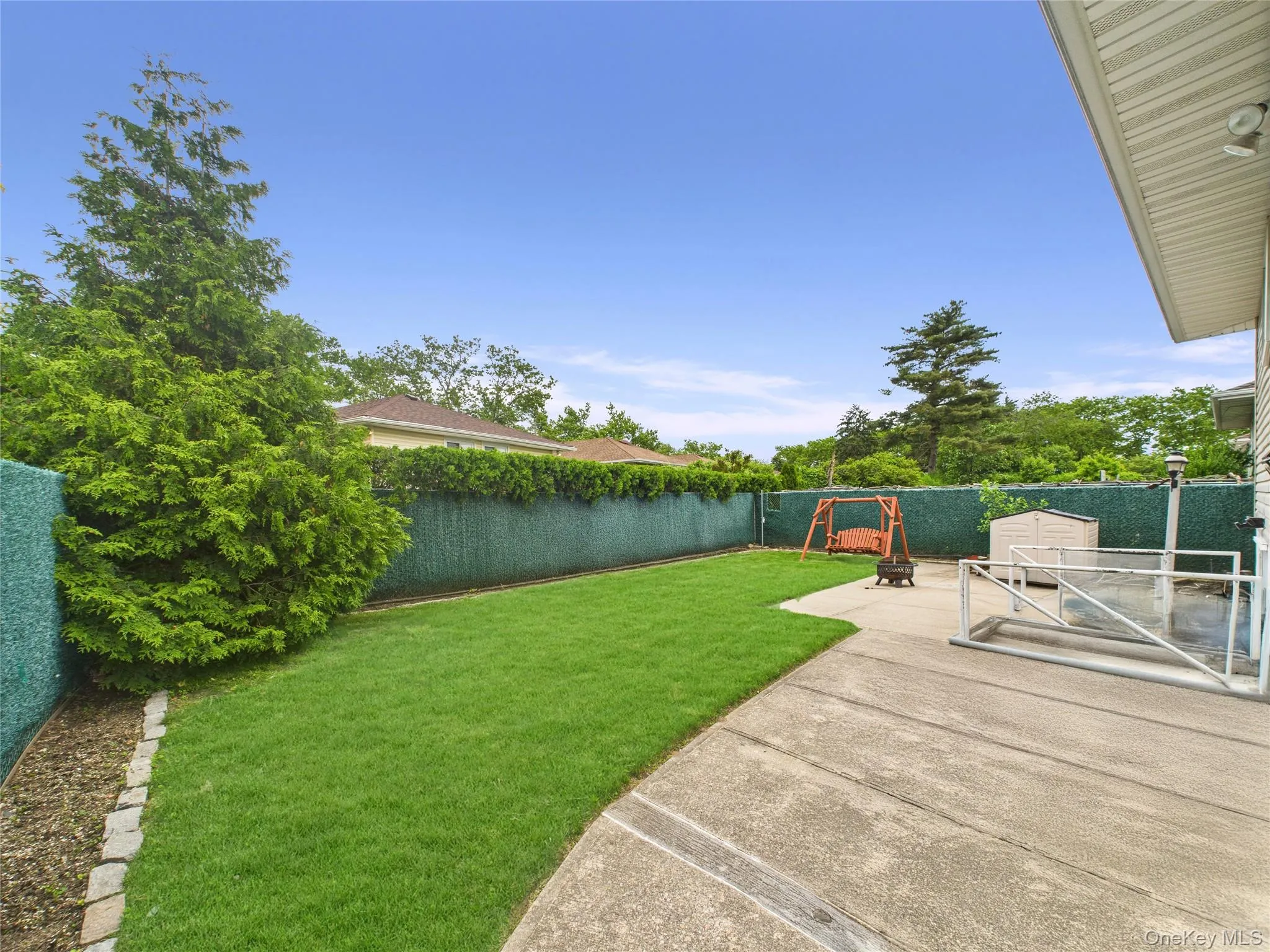 View of yard featuring a playground and a patio View of yard featuring a playground and a patio