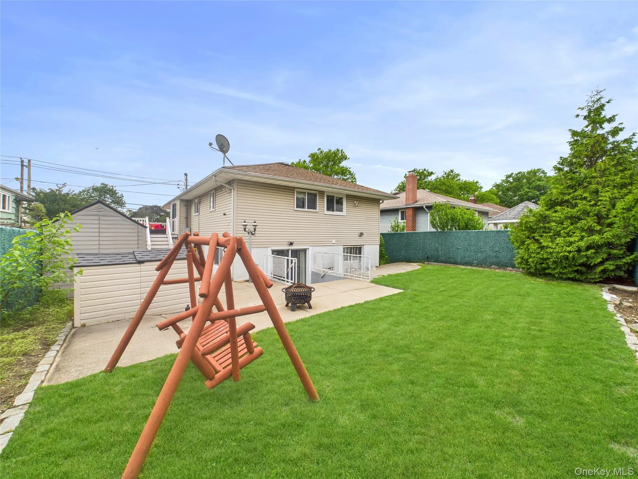 Back of property featuring a patio area and an outdoor fire pit Back of property featuring a patio area and an outdoor fire pit