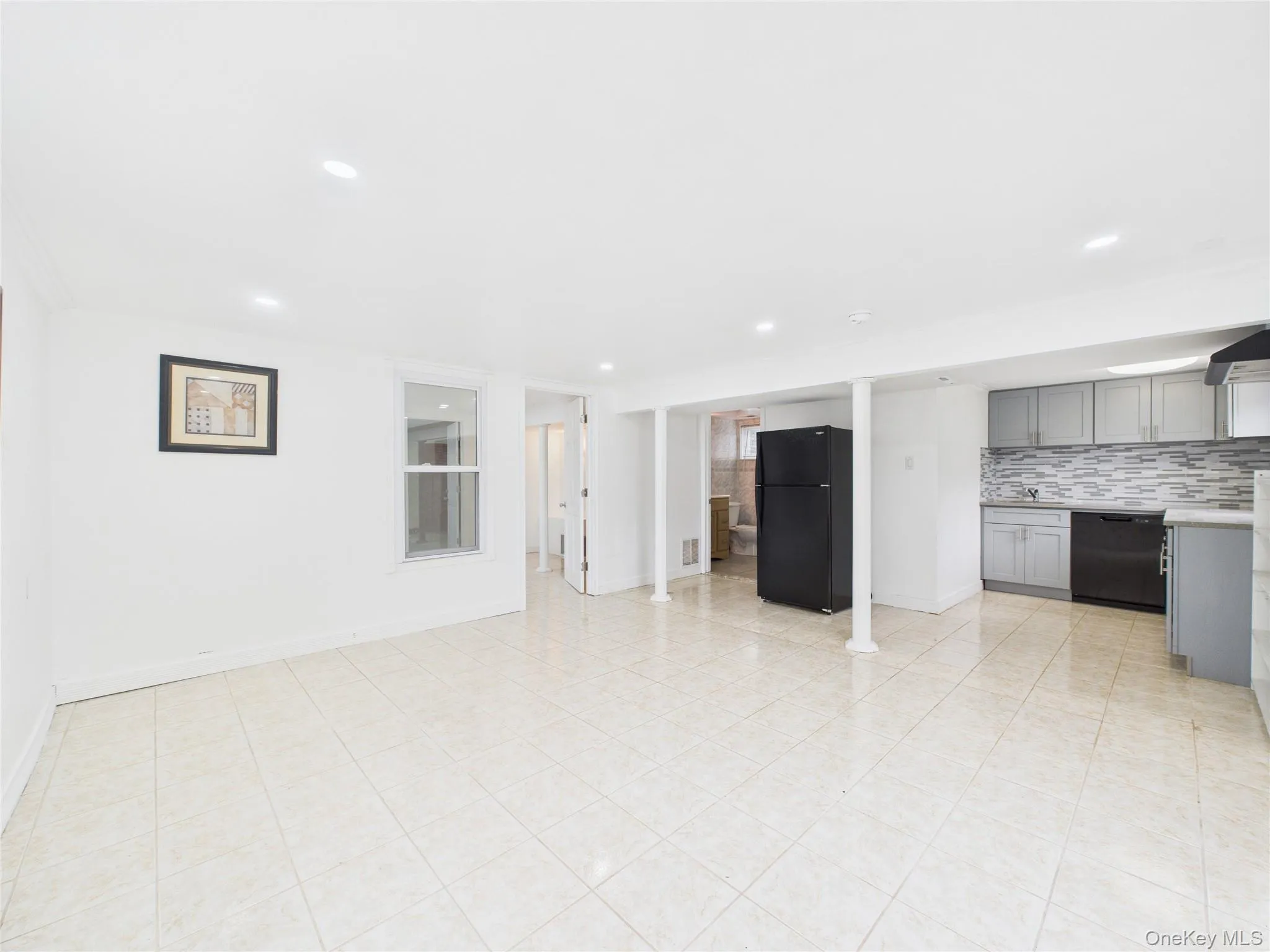 Unfurnished living room featuring baseboards and recessed lighting Unfurnished living room featuring baseboards and recessed lighting