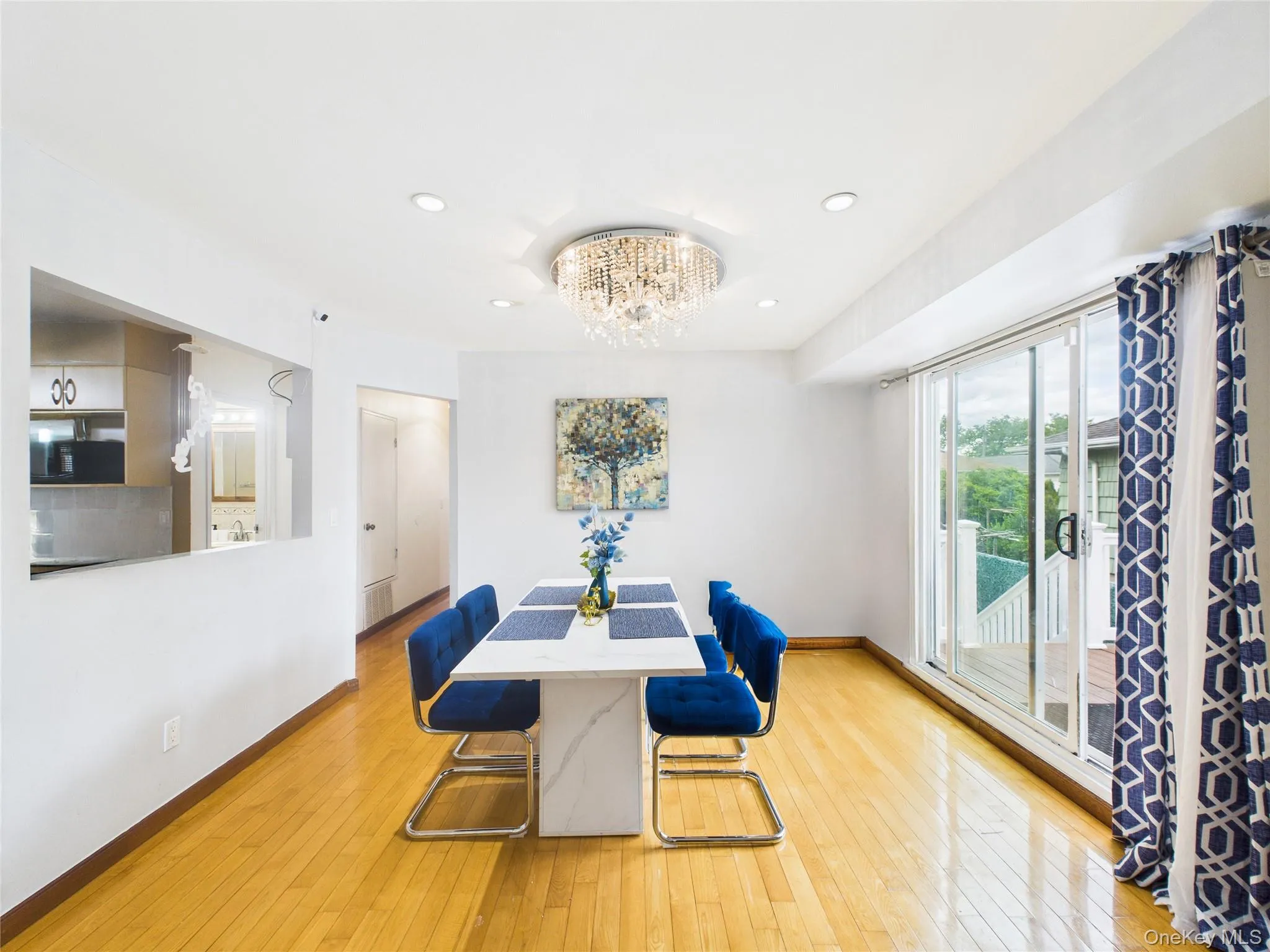 Dining area featuring baseboards, light wood-type flooring, a chandelier, and recessed lighting Dining area featuring baseboards, light wood-type flooring, a chandelier, and recessed lighting