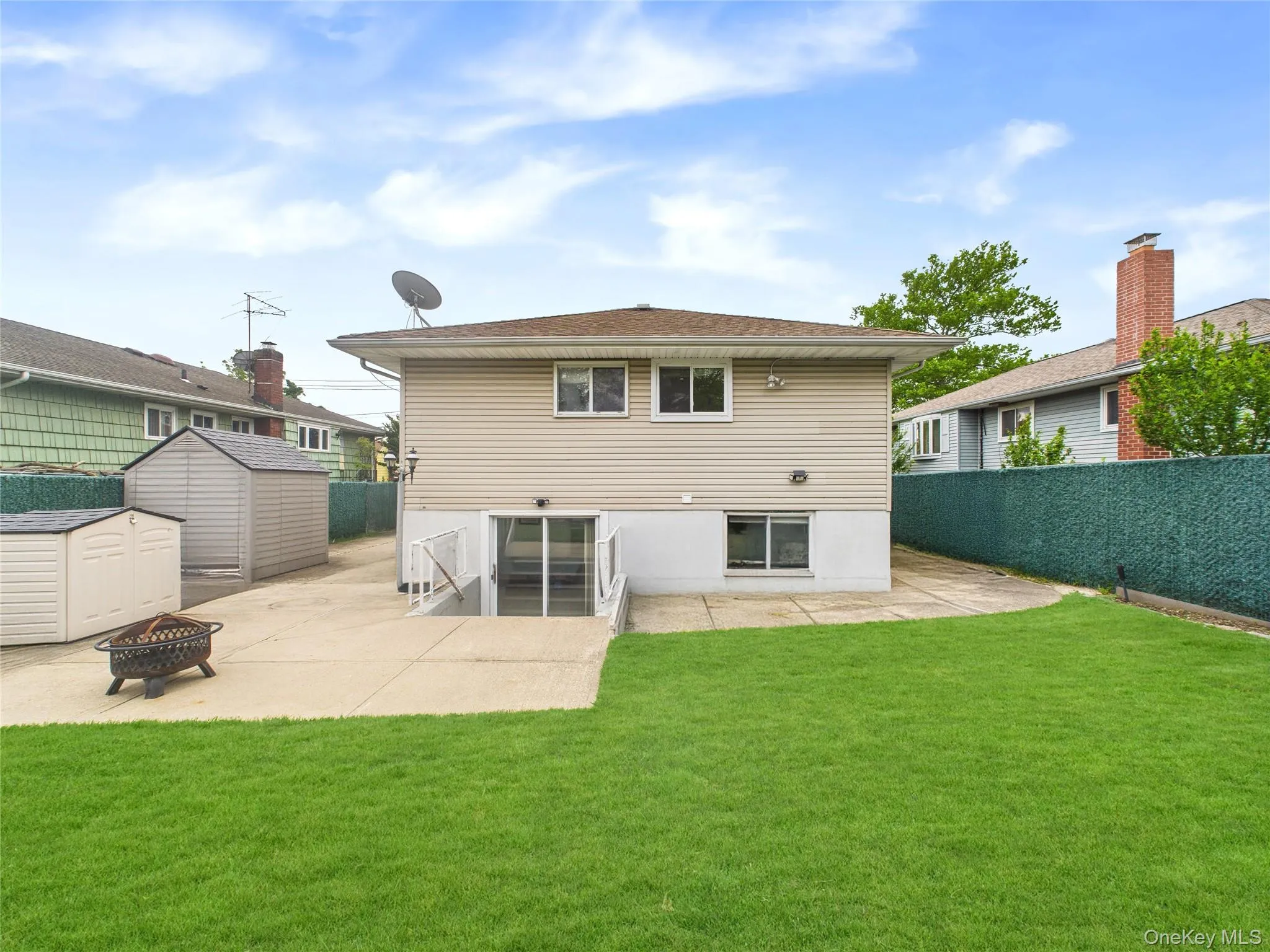 Back of property with a fire pit and a patio area Back of property with a fire pit and a patio area