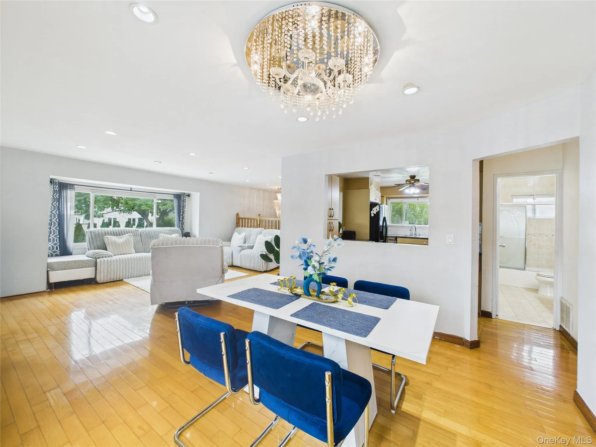 Dining room with light wood finished floors, a chandelier, and recessed lighting Dining room with light wood finished floors, a chandelier, and recessed lighting
