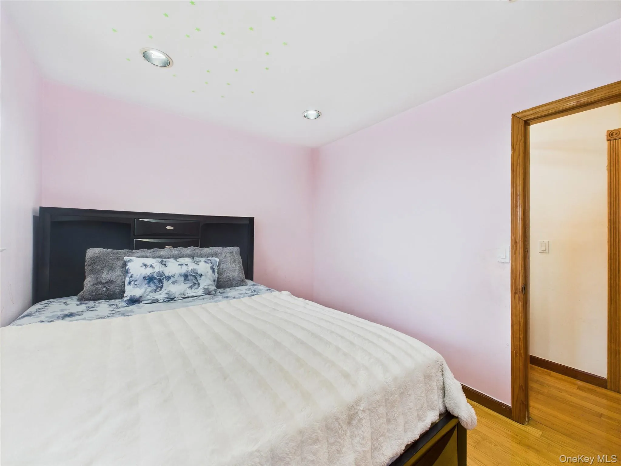Bedroom with light wood-type flooring, baseboards, and recessed lighting Bedroom with light wood-type flooring, baseboards, and recessed lighting
