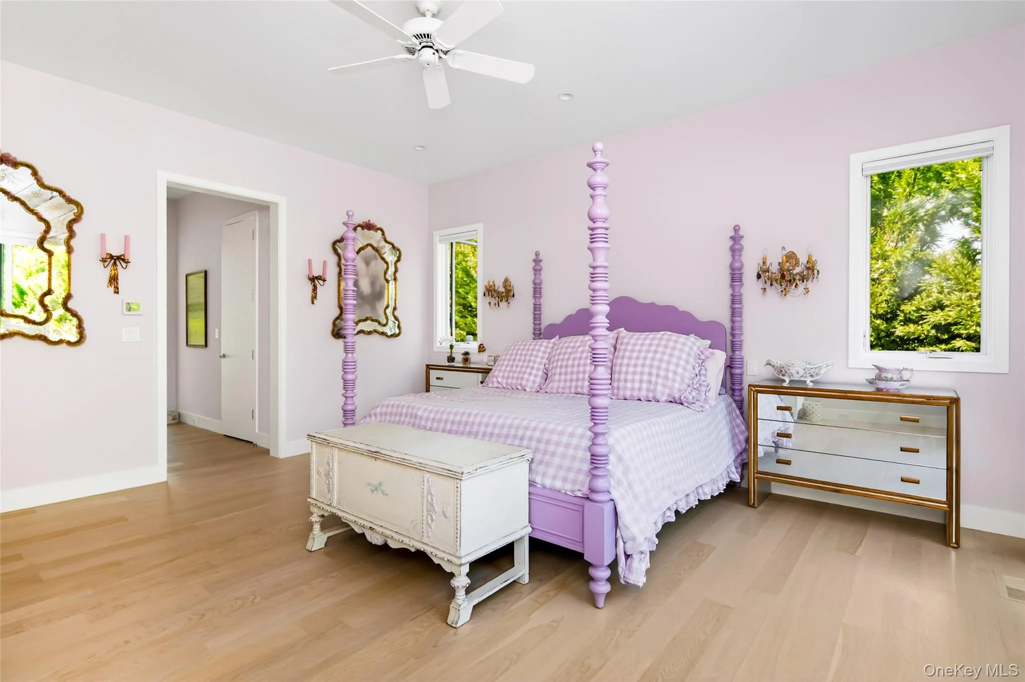 Spacious First Floor Primary room featuring light wood-finish flooring, white baseboards, and a white ceiling with a ceiling fan Spacious First Floor Primary room featuring light wood-finish flooring, white baseboards, and a white ceiling with a ceiling fan