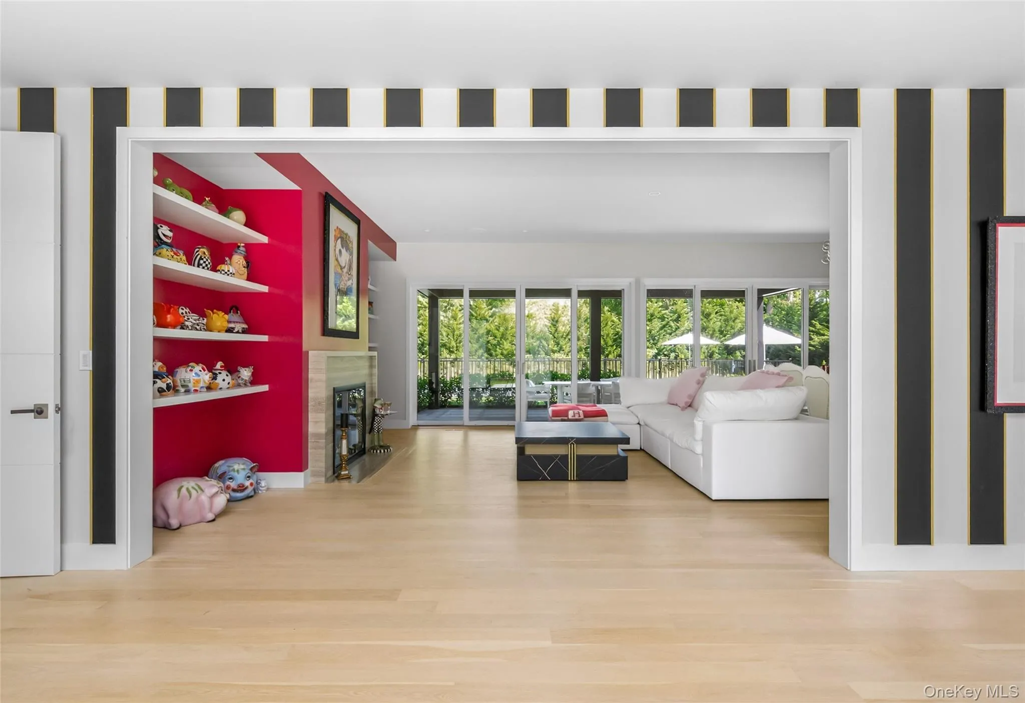 Hardwood-finish flooring extending into an open-concept living space with a fireplace and built-in shelving Hardwood-finish flooring extending into an open-concept living space with a fireplace and built-in shelving