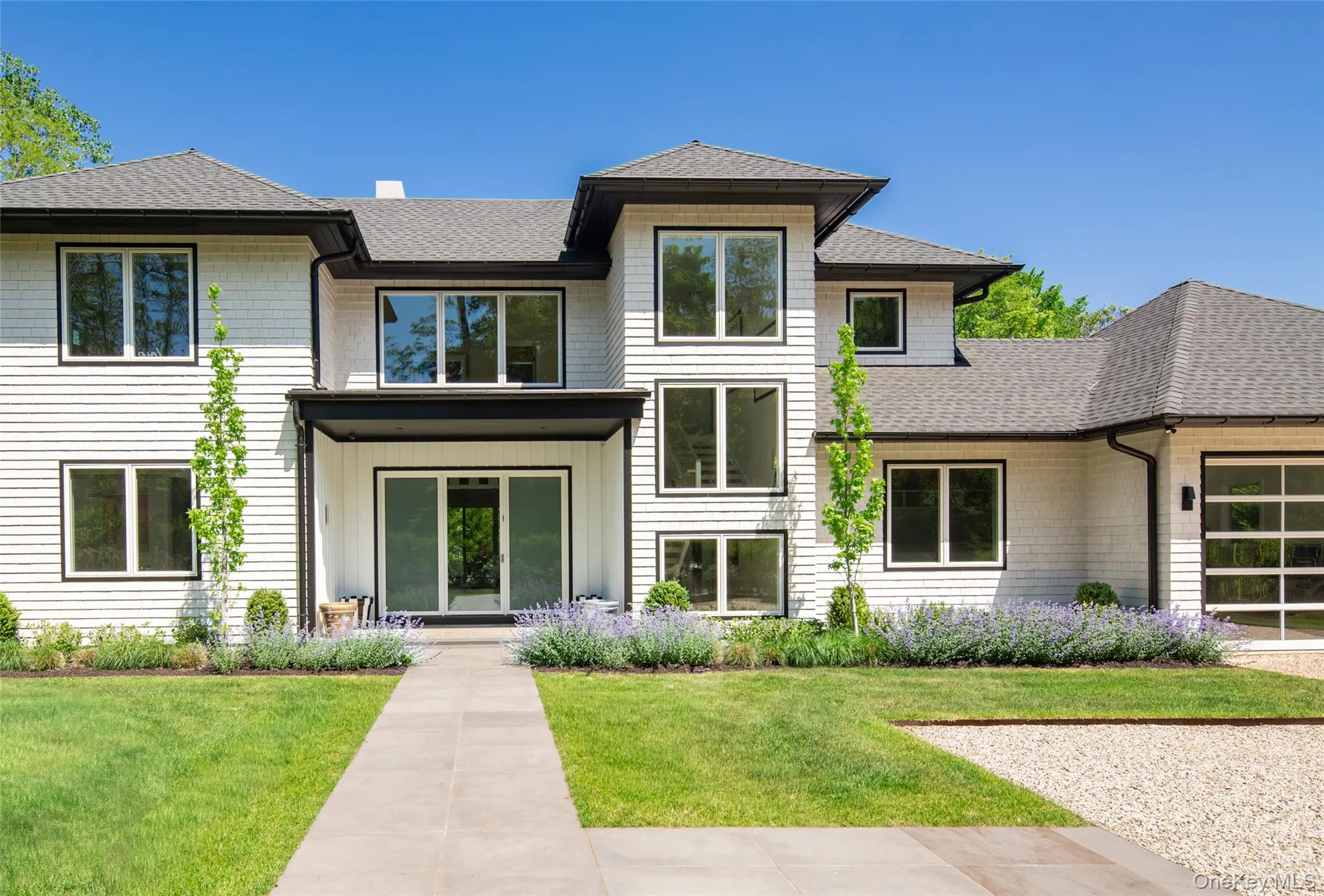 Contemporary architecture with white horizontal siding and black trim accents Contemporary architecture with white horizontal siding and black trim accents