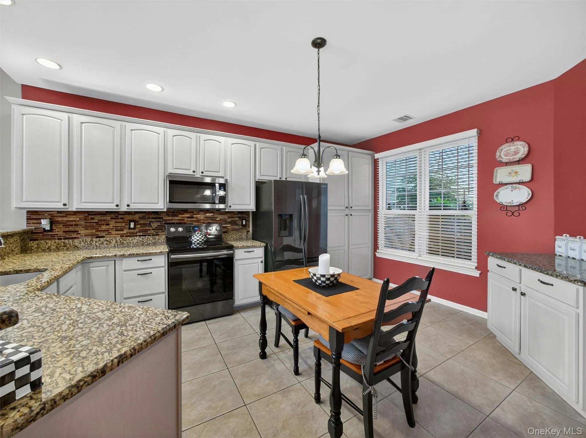 Generous cabinetry and counterspace with a double-window overlooking the professionally landscaped cobblestone walkway. Generous cabinetry and counterspace with a double-window overlooking the professionally landscaped cobblestone walkway.