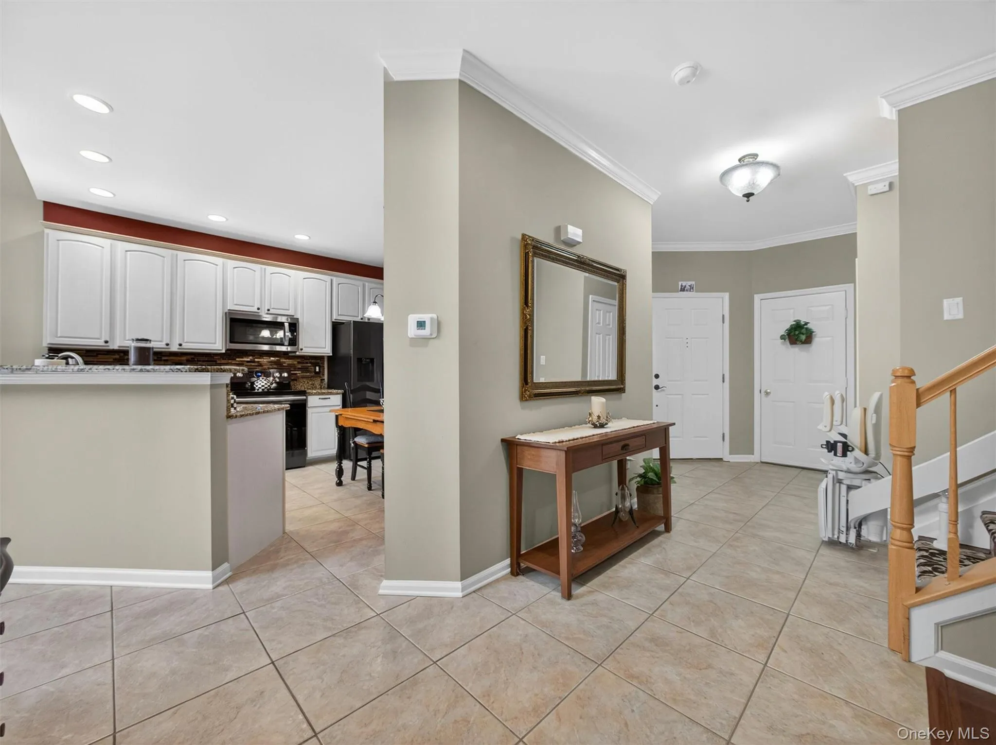 View to the entryway foyer and garage access. Open-plan kitchen to the left. View to the entryway foyer and garage access. Open-plan kitchen to the left.