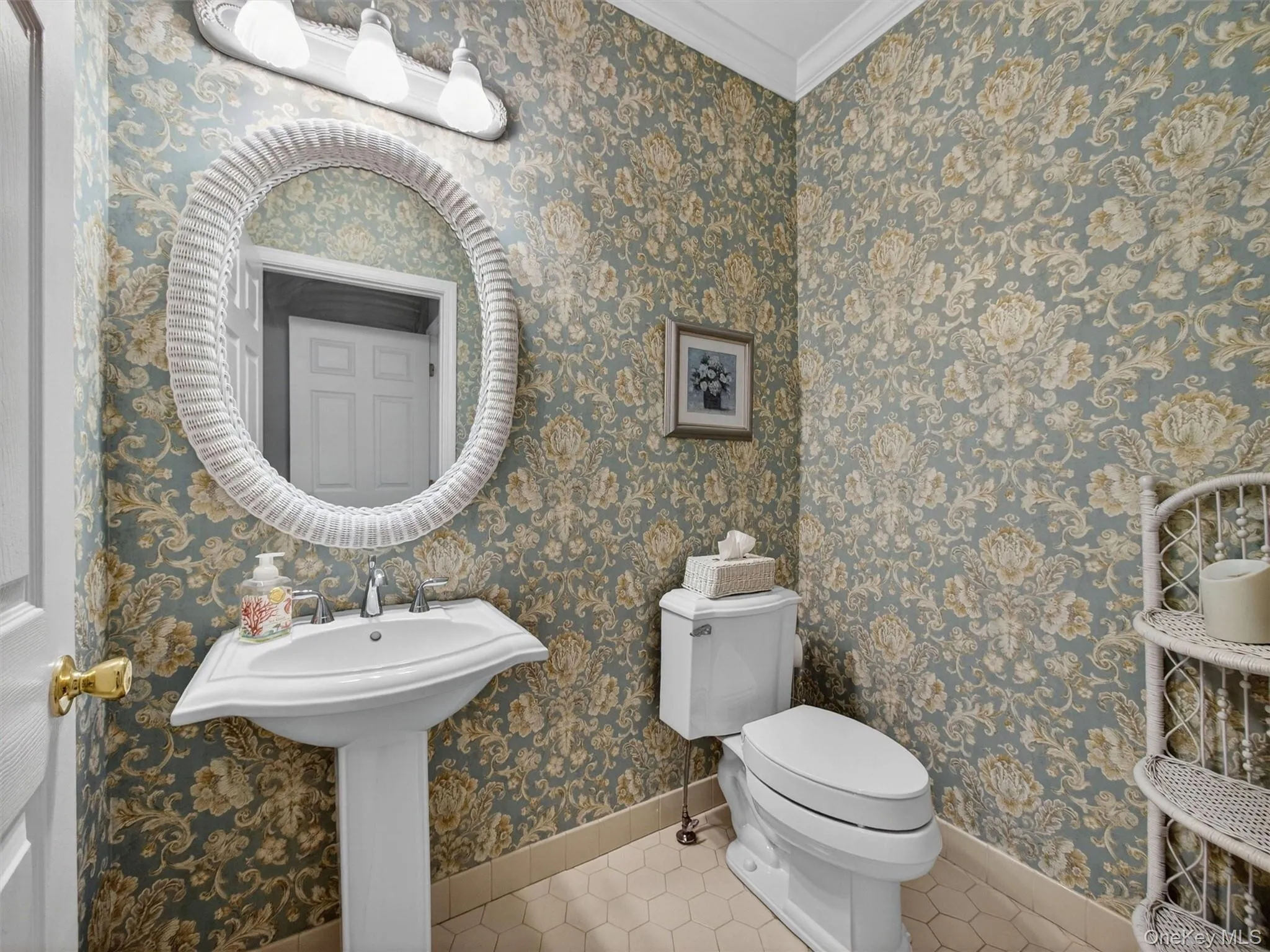 Elegant first floor powder room with wallcovering. Elegant first floor powder room with wallcovering.