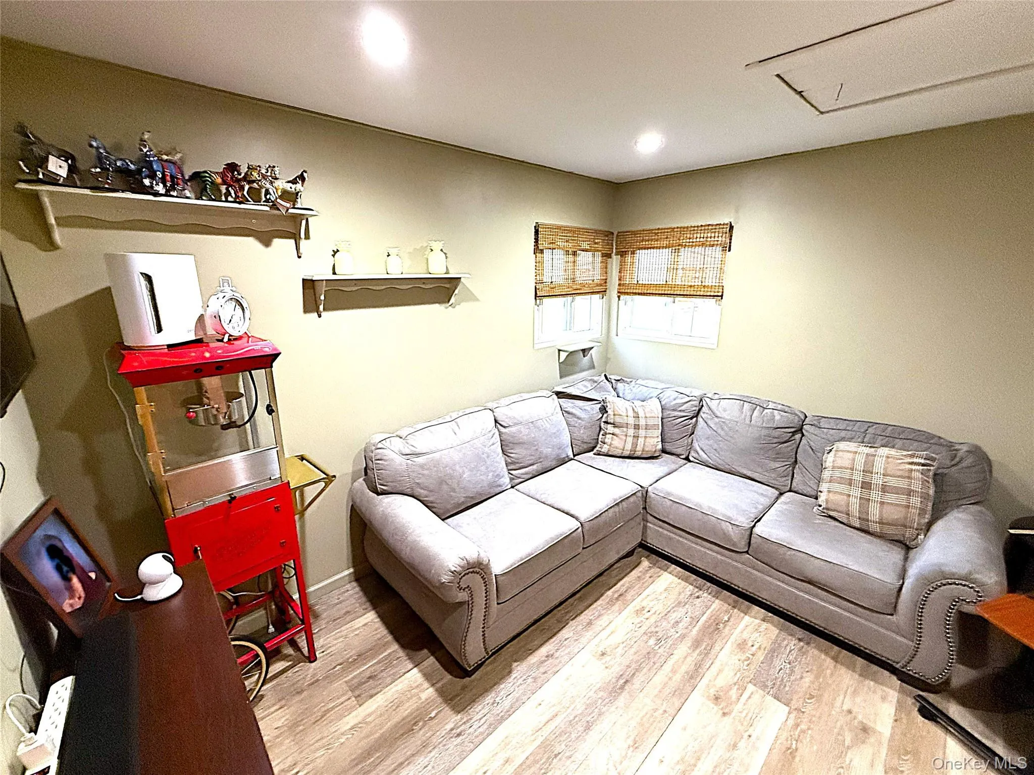 Corner space featuring wood-finish flooring and recessed ceiling lighting Corner space featuring wood-finish flooring and recessed ceiling lighting