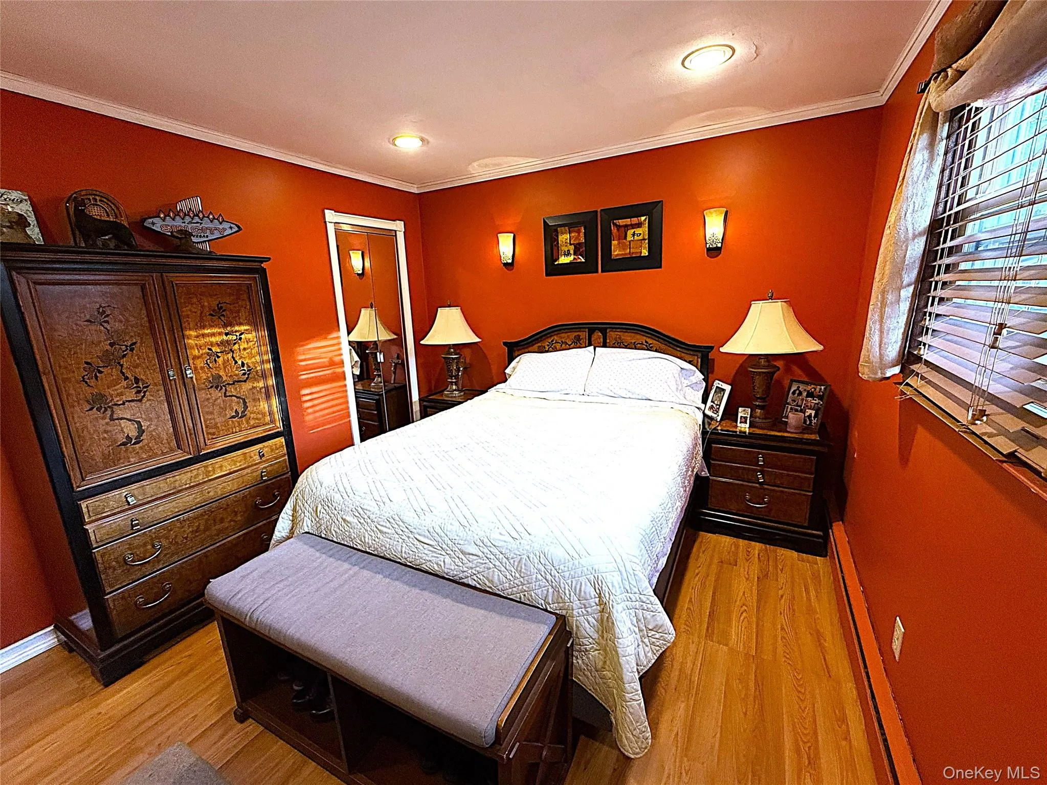 Room featuring wood-finish flooring, recessed ceiling lighting, and crown molding Room featuring wood-finish flooring, recessed ceiling lighting, and crown molding