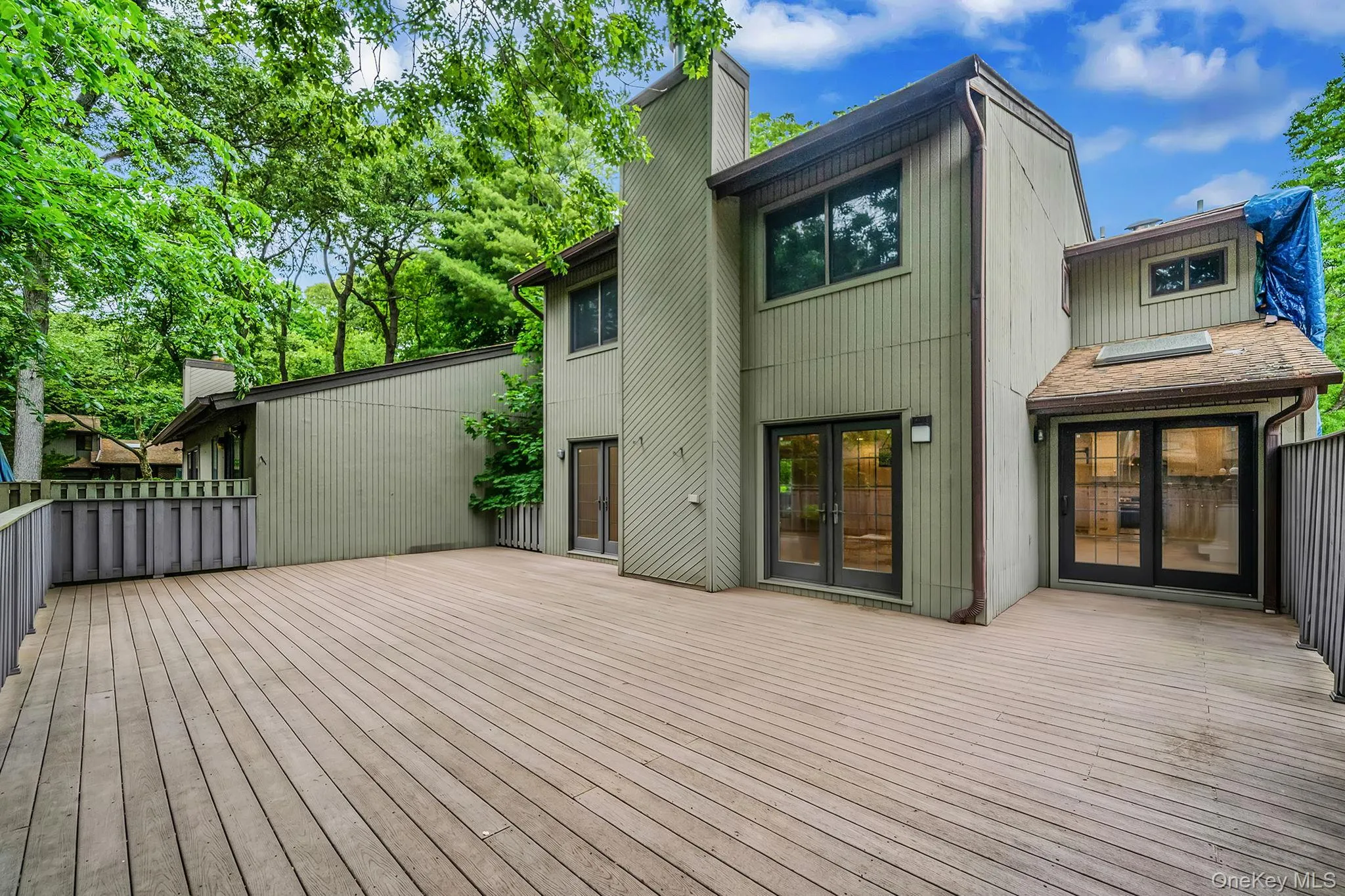 Expansive outdoor decking features a composite surface and perimeter railing Expansive outdoor decking features a composite surface and perimeter railing