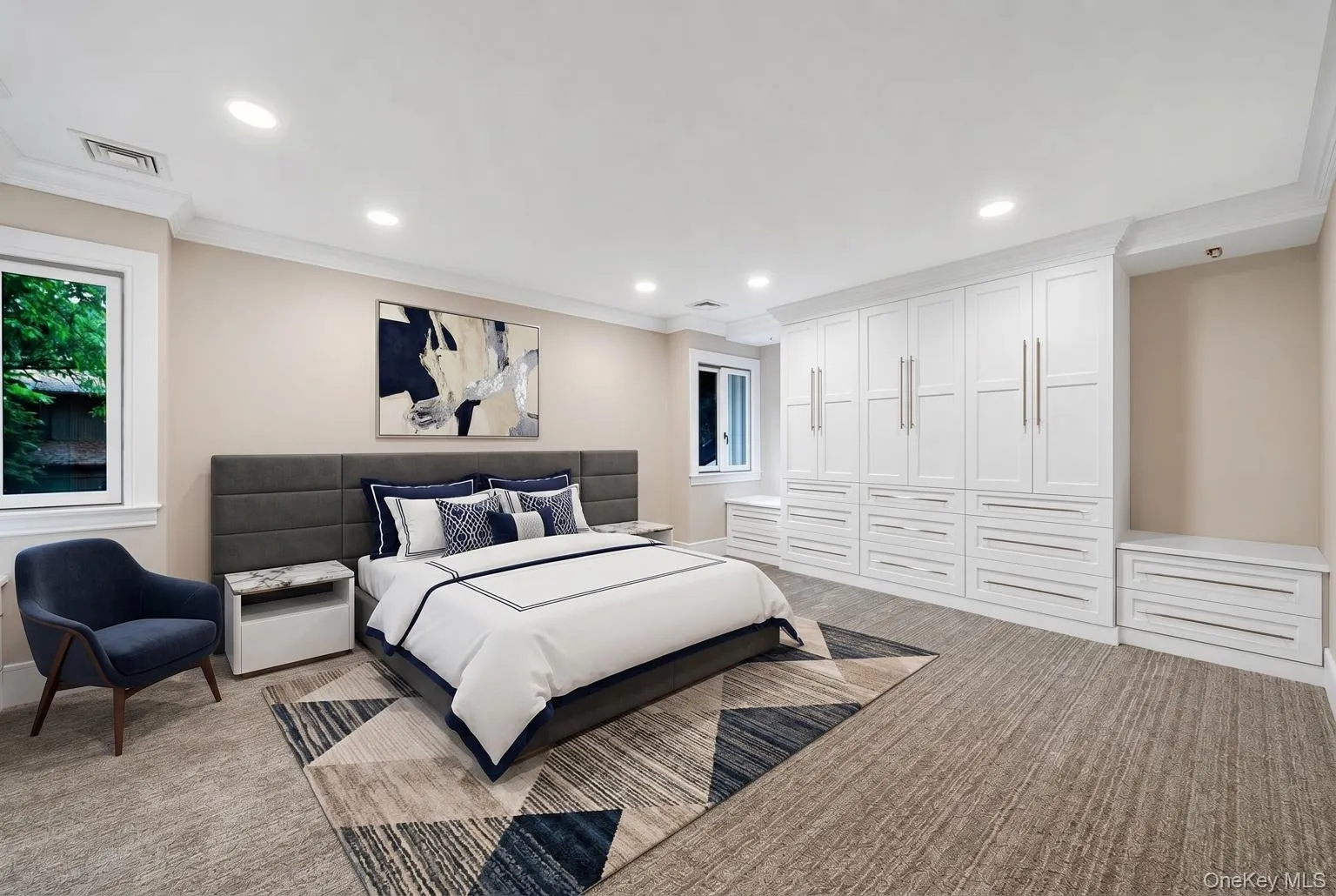 Room featuring extensive built-in white cabinetry, recessed lighting, and crown molding Room featuring extensive built-in white cabinetry, recessed lighting, and crown molding