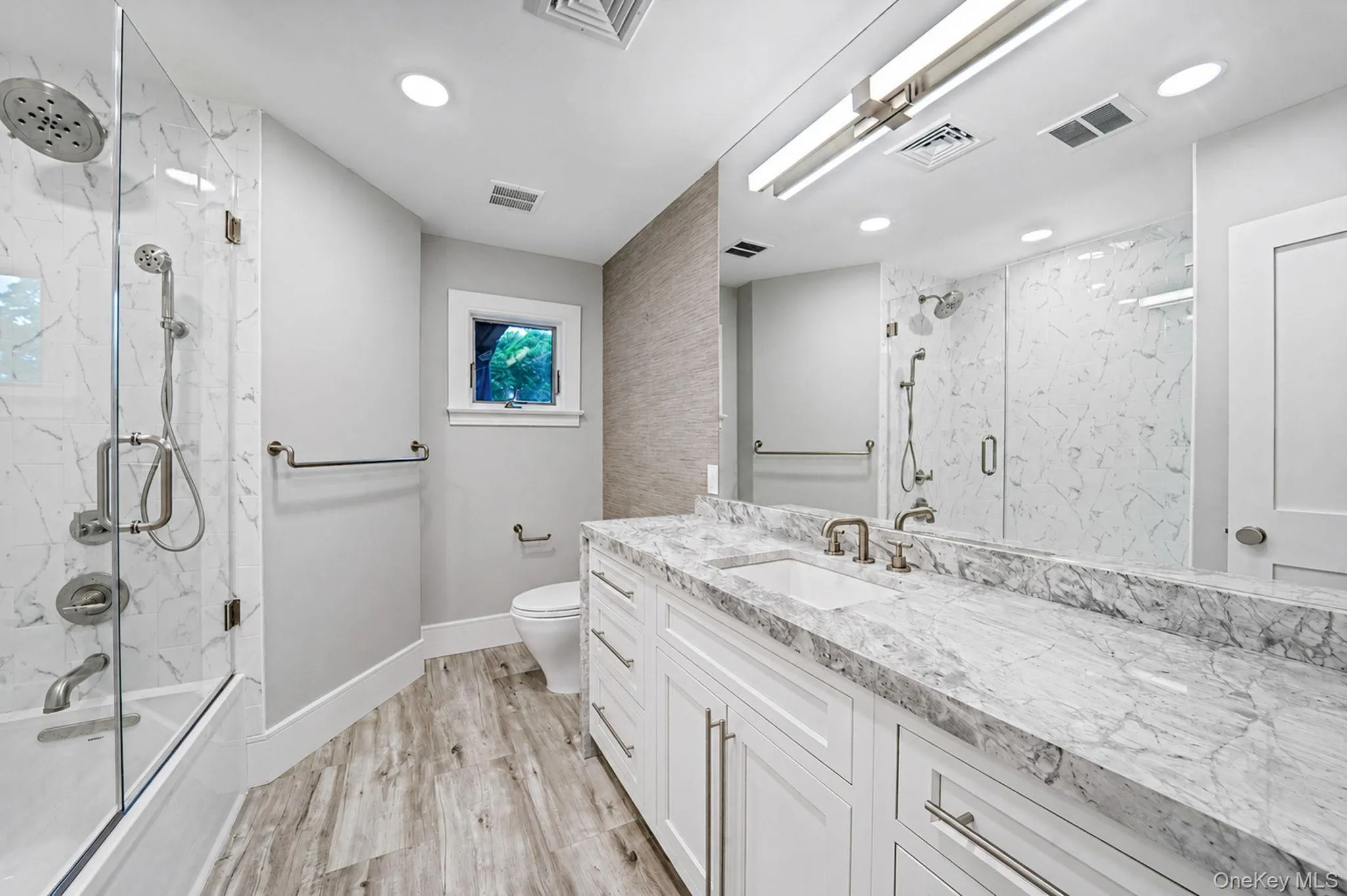 Dual vanity with a stone countertop and integrated sink Dual vanity with a stone countertop and integrated sink