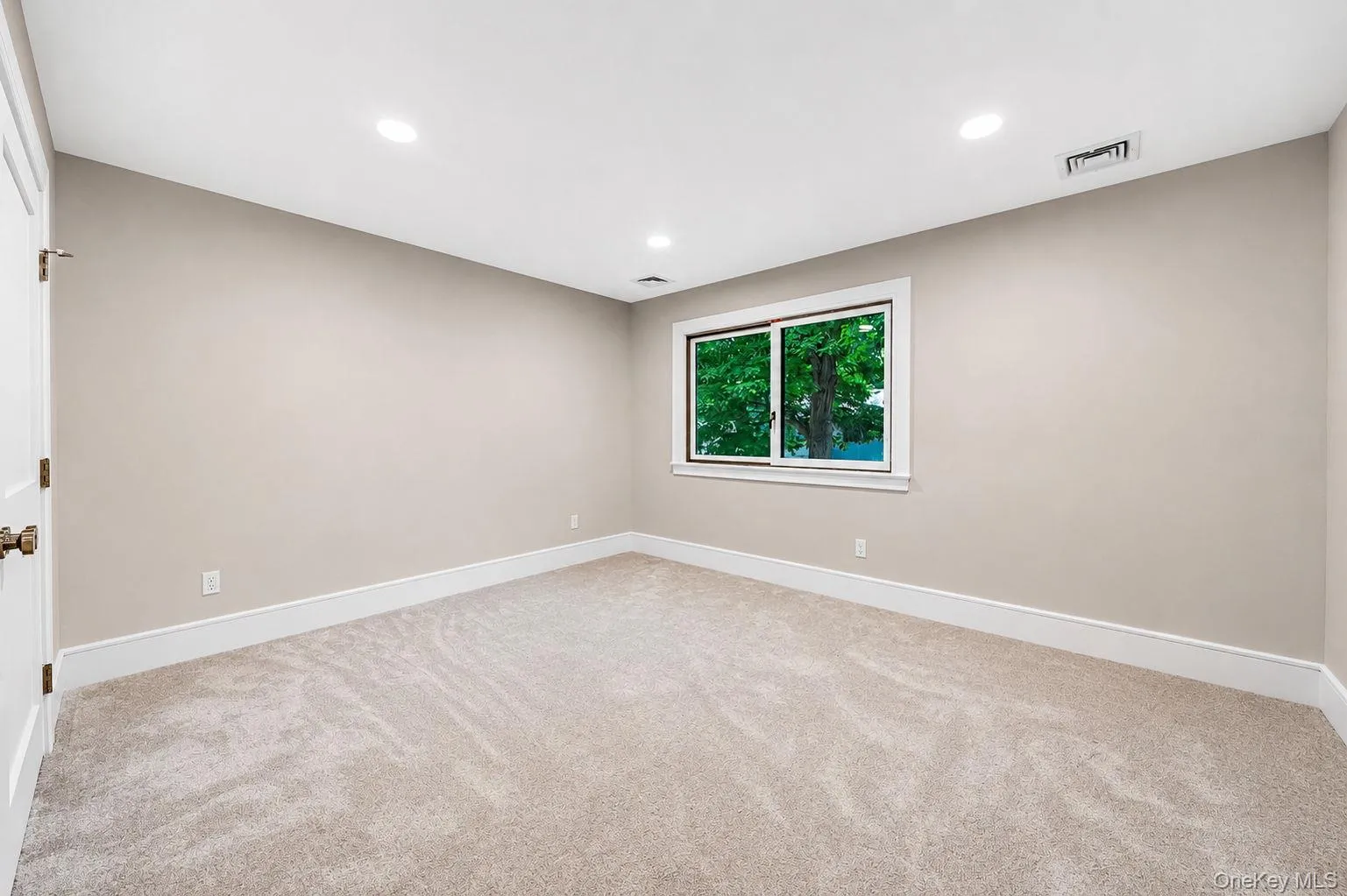 Neutral-toned wall paint, recessed lighting, and plush carpeting create a refined interior Neutral-toned wall paint, recessed lighting, and plush carpeting create a refined interior
