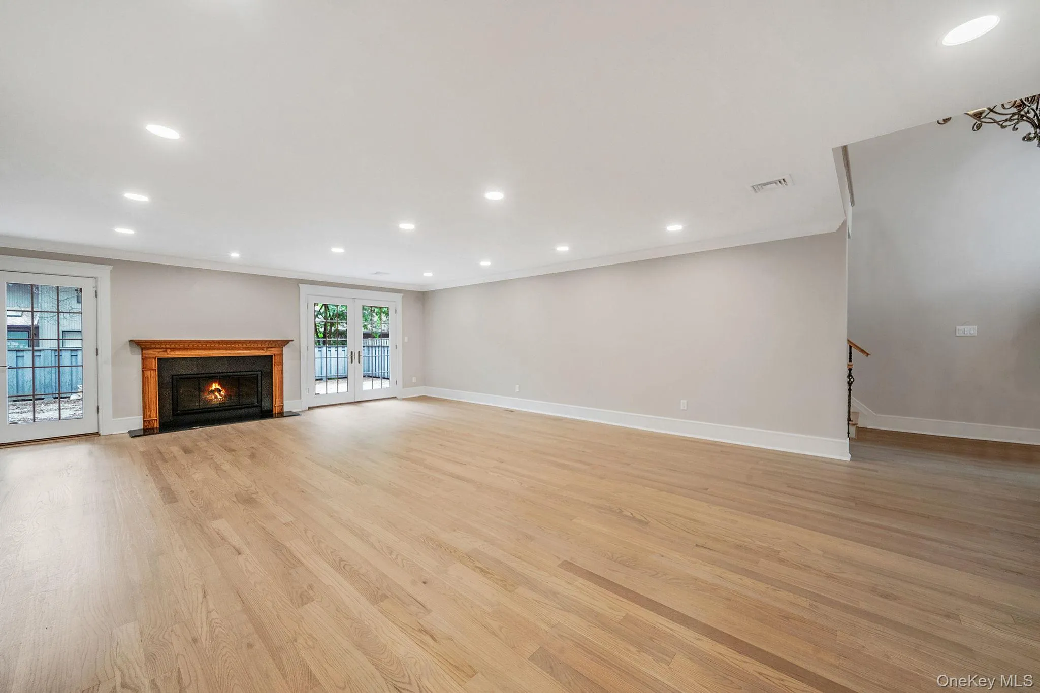 Spacious room featuring light wood-finish flooring and recessed ceiling lighting Spacious room featuring light wood-finish flooring and recessed ceiling lighting