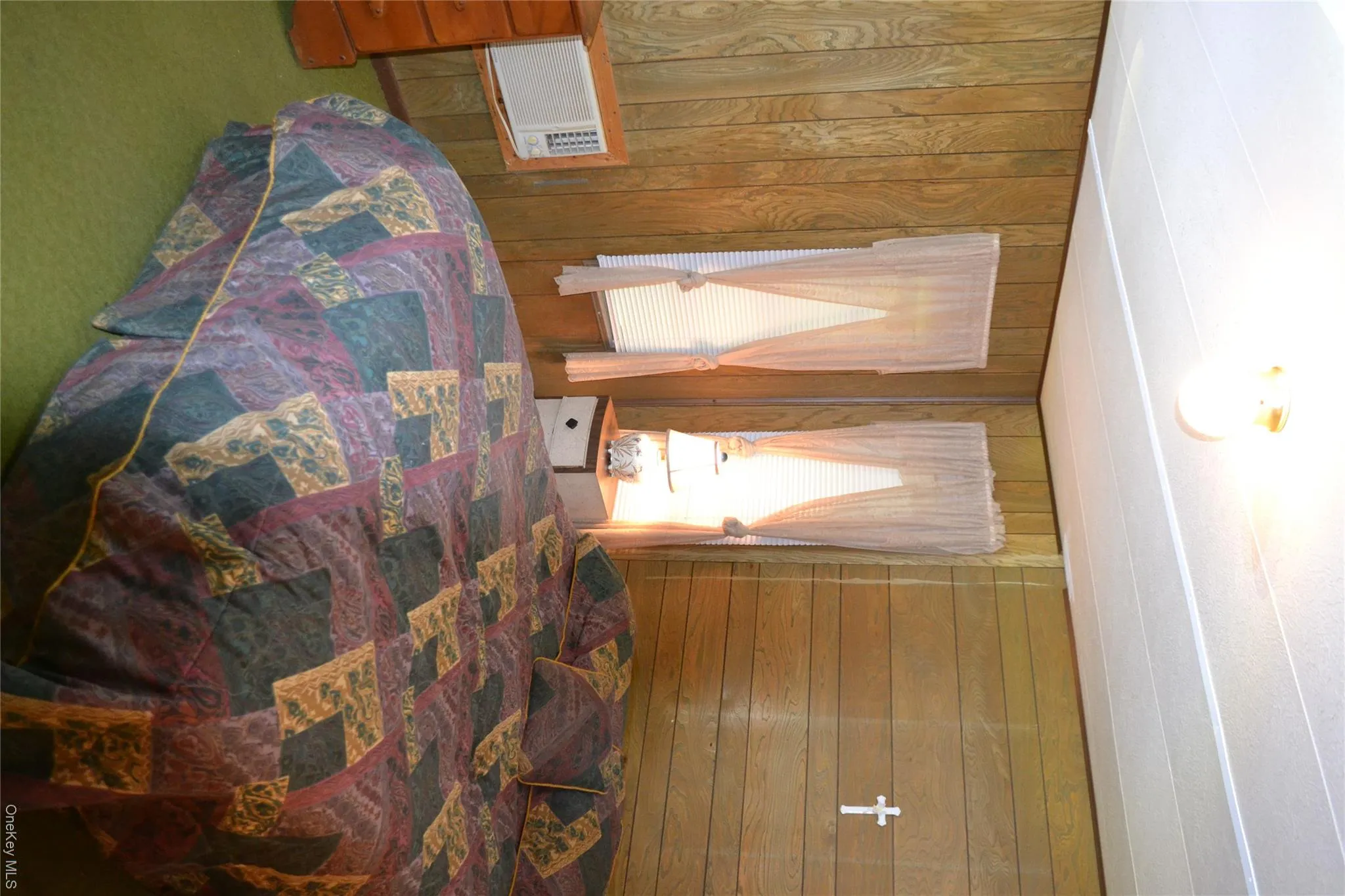 Primary bedroom with wall A/C and 4 custom windows Primary bedroom with wall A/C and 4 custom windows