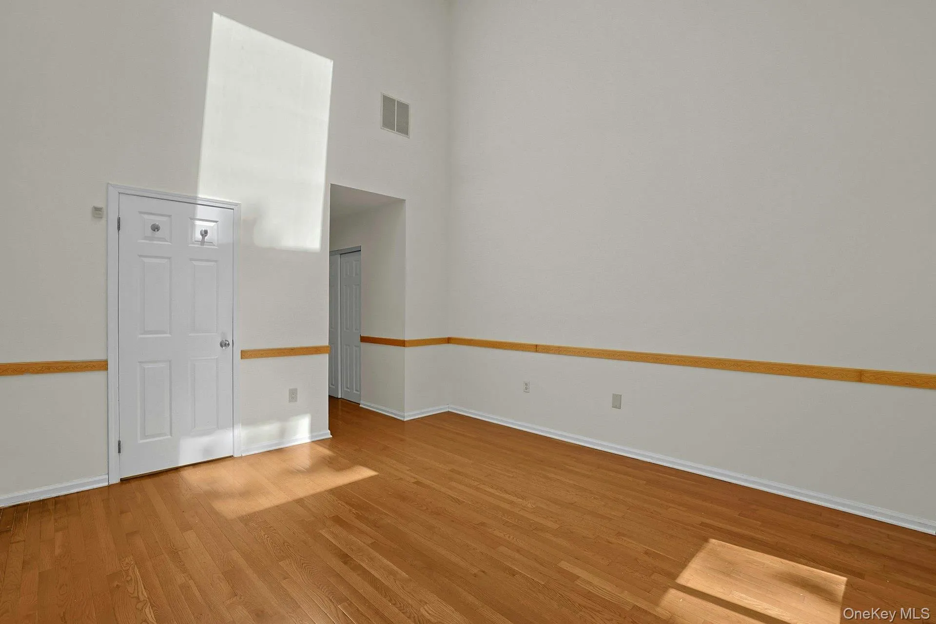 Door to primary bath and small hall with 2 double closets Door to primary bath and small hall with 2 double closets