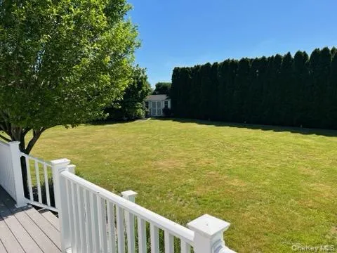 Spacious backyard featuring a manicured lawn, established privacy hedges, and a functional storage shed Spacious backyard featuring a manicured lawn, established privacy hedges, and a functional storage shed