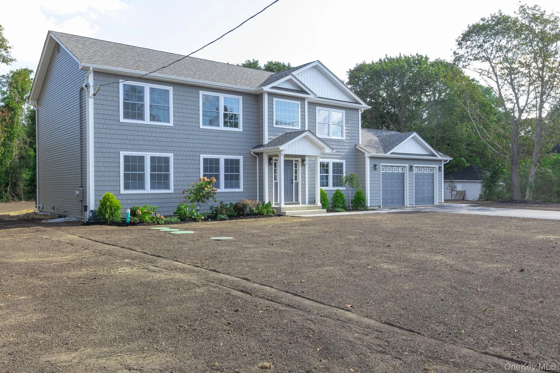 View of front of home featuring concrete driveway, roof with shingles, and a garage View of front of home featuring concrete driveway, roof with shingles, and a garage