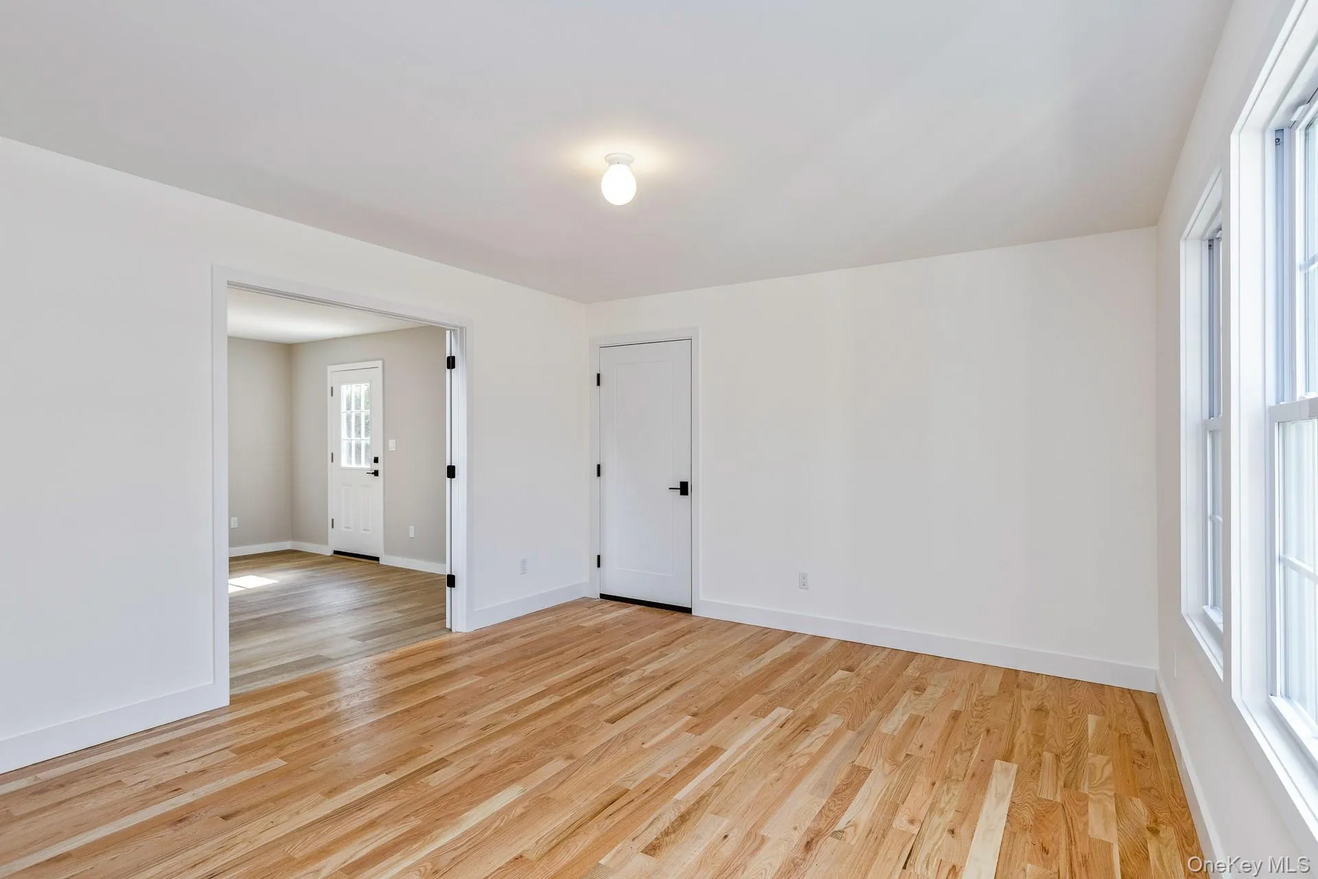 Spare room with light wood-type flooring and baseboards Spare room with light wood-type flooring and baseboards