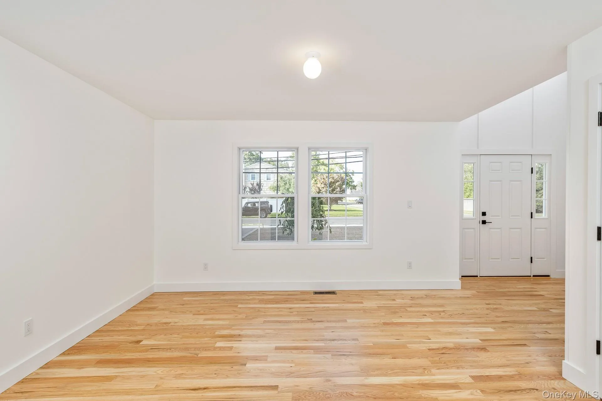 Foyer featuring light wood-style flooring and baseboards Foyer featuring light wood-style flooring and baseboards