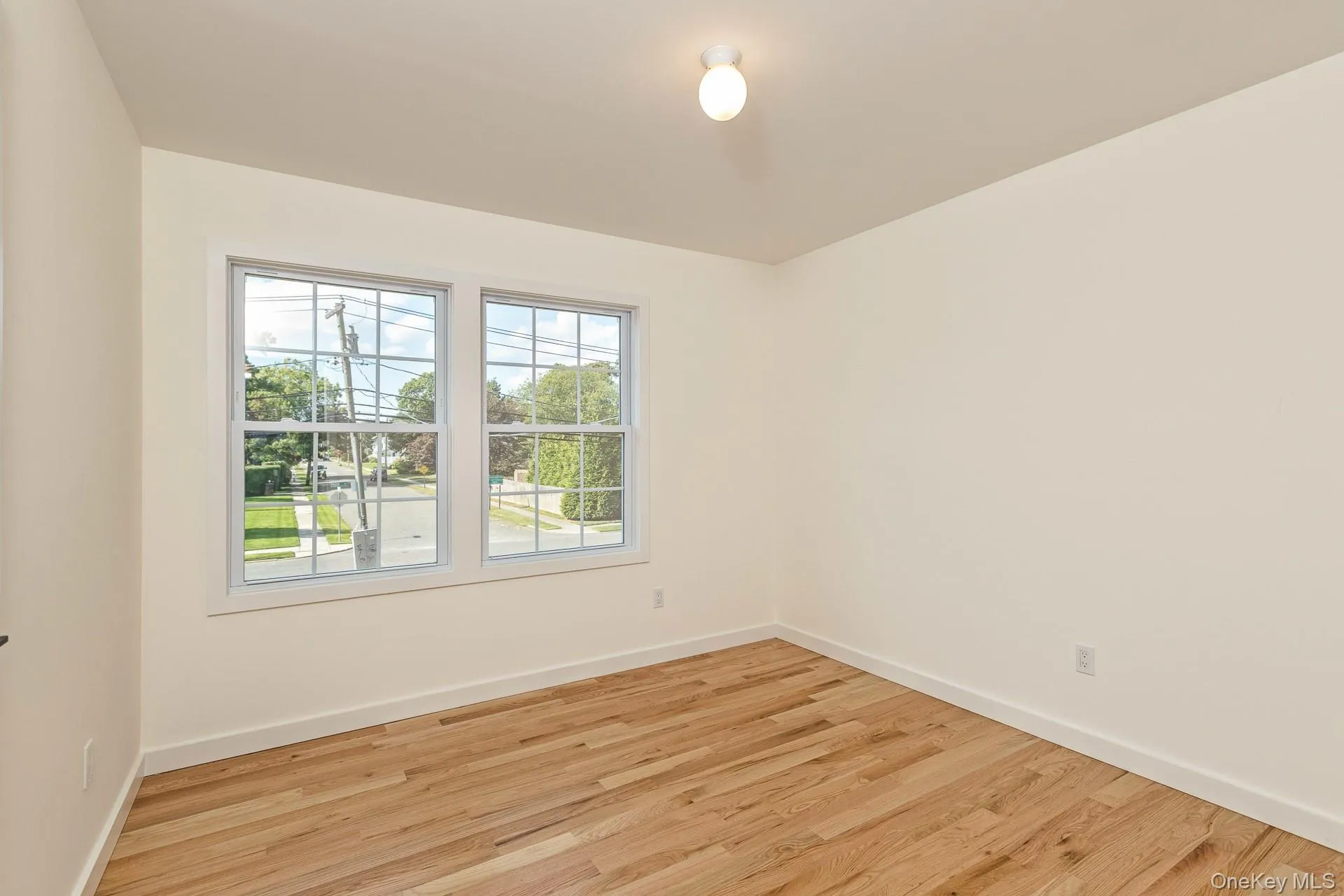 Empty room featuring light wood-style flooring and baseboards Empty room featuring light wood-style flooring and baseboards