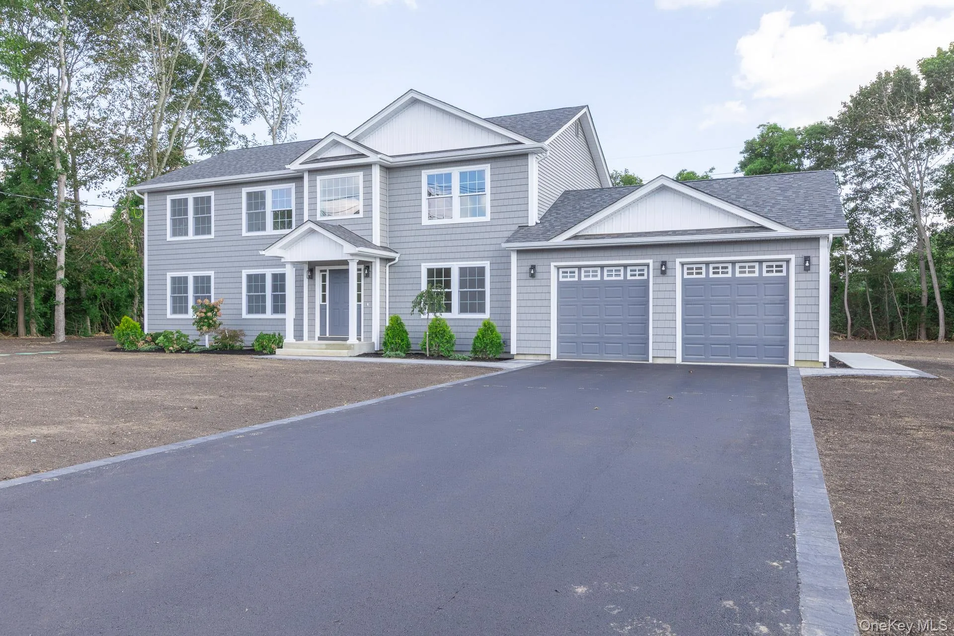View of front of home with driveway, roof with shingles, and an attached garage View of front of home with driveway, roof with shingles, and an attached garage