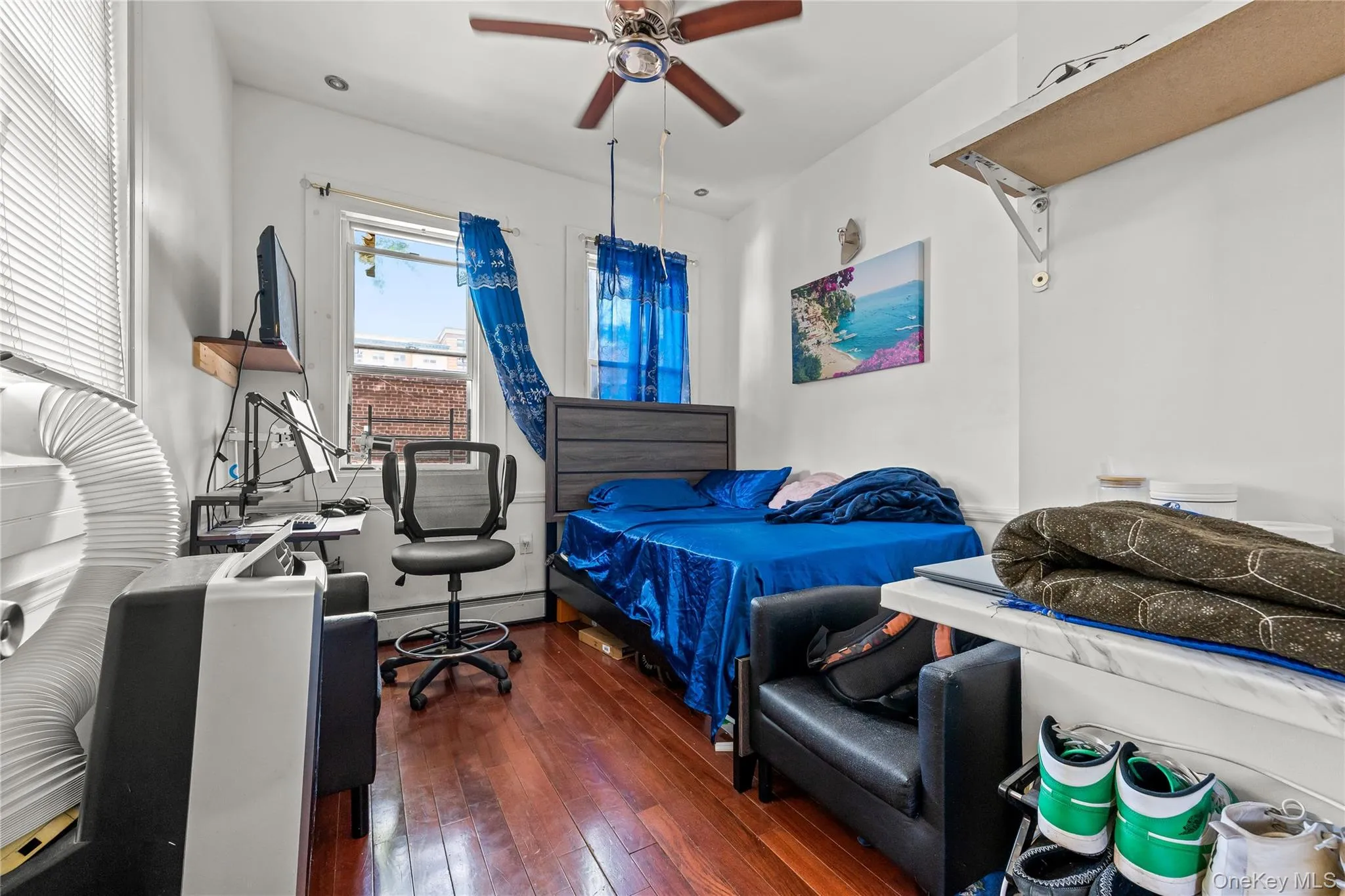 Hardwood flooring with a ceiling fan and overhead lighting Hardwood flooring with a ceiling fan and overhead lighting