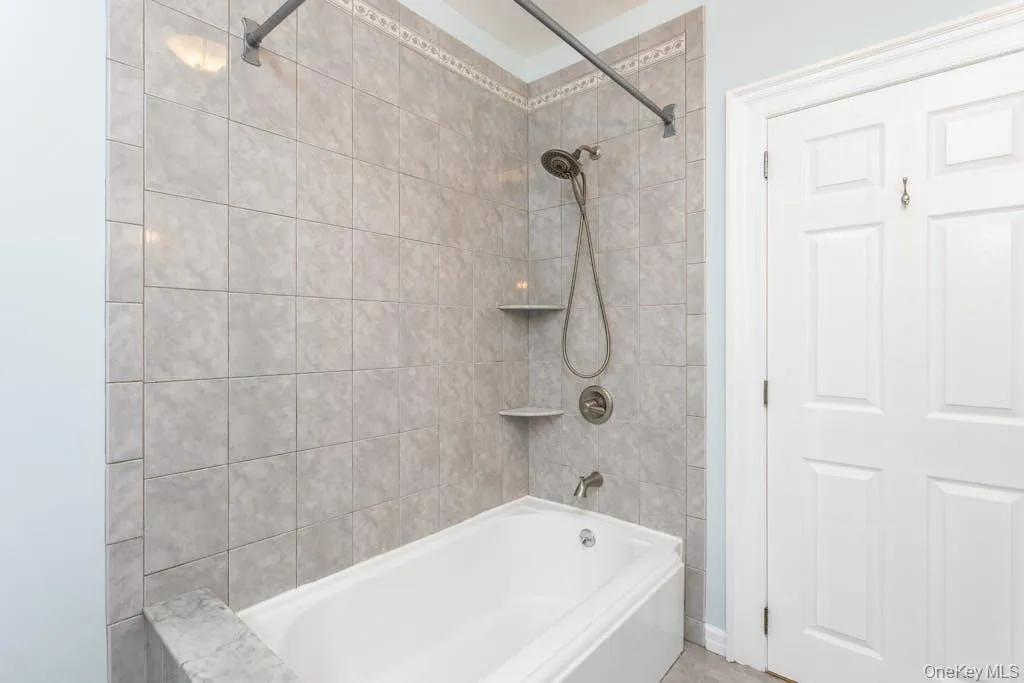 View 2 of bathroom featuring tiled shower / bath View 2 of bathroom featuring tiled shower / bath