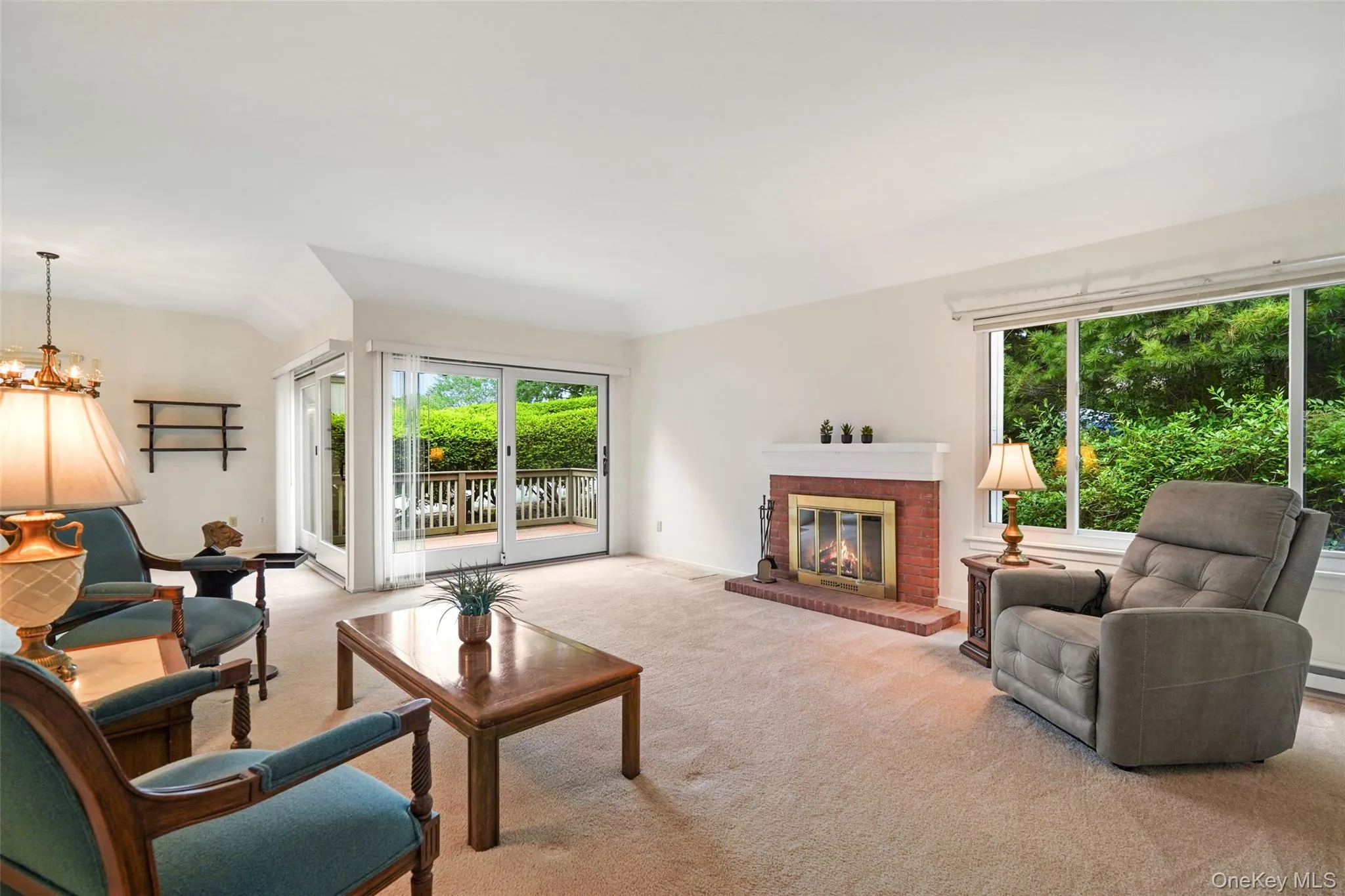 Formal living room with fireplace and Andersen slider out to backyard deck Formal living room with fireplace and Andersen slider out to backyard deck