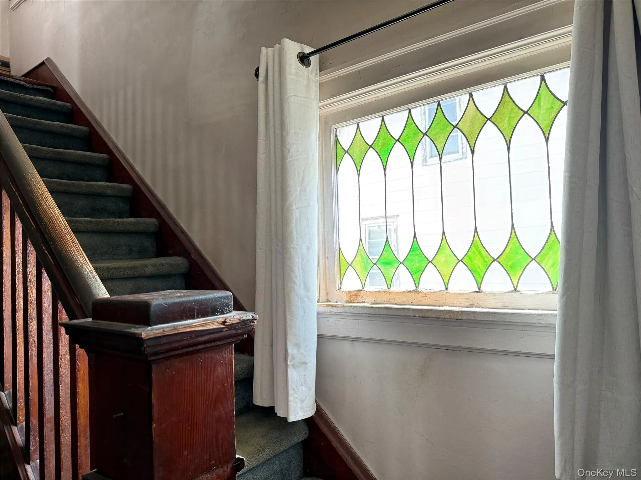 View of stairs with stained glass window View of stairs with stained glass window