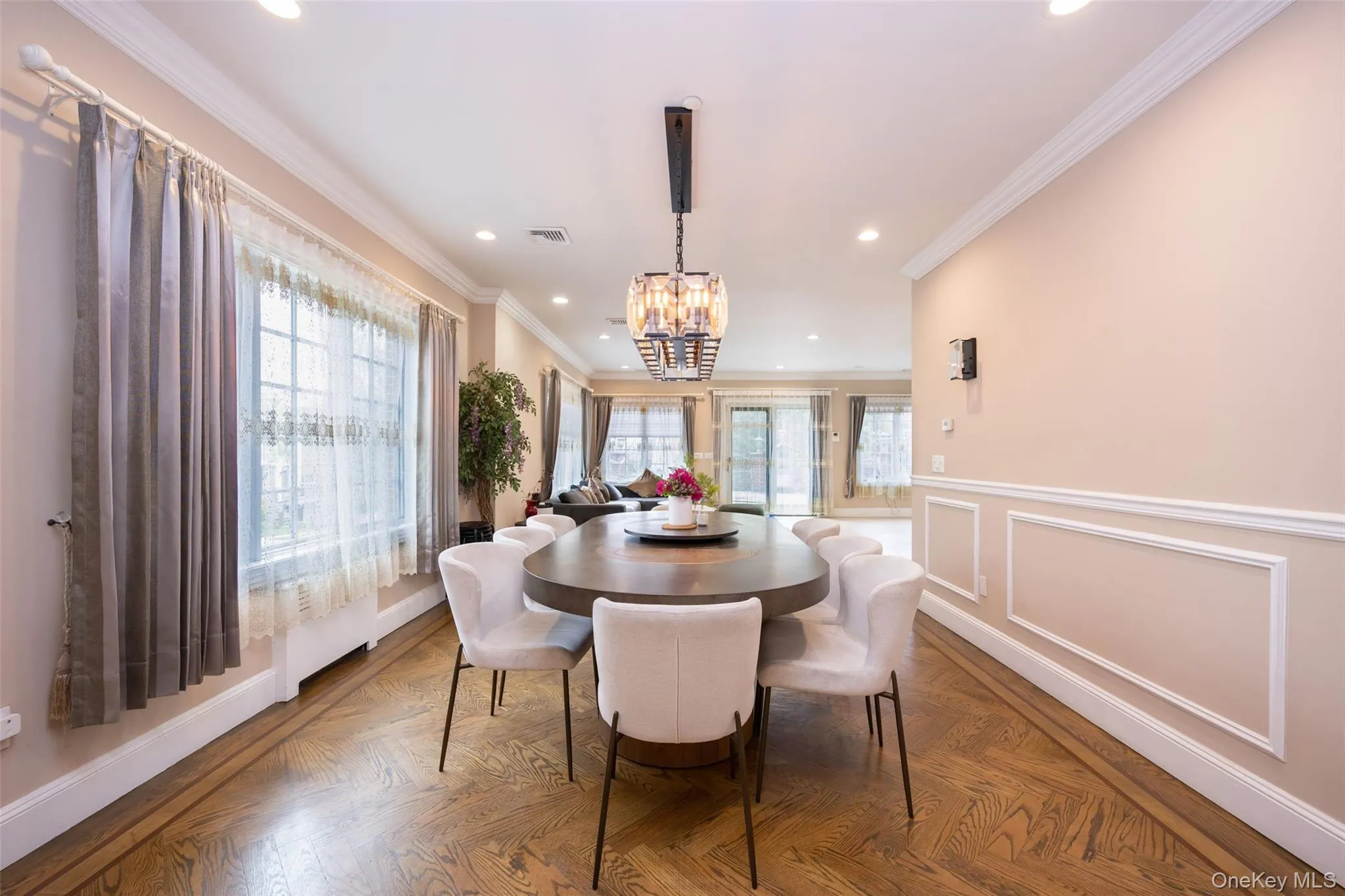 Dining space featuring recessed lighting, a chandelier, crown molding, and baseboards Dining space featuring recessed lighting, a chandelier, crown molding, and baseboards