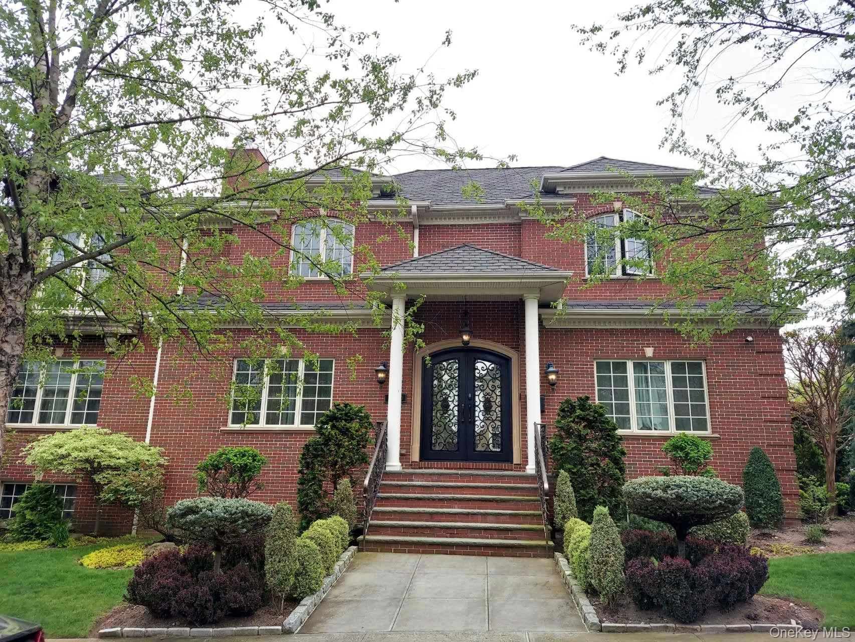 View of front of home with brick siding and french doors View of front of home with brick siding and french doors