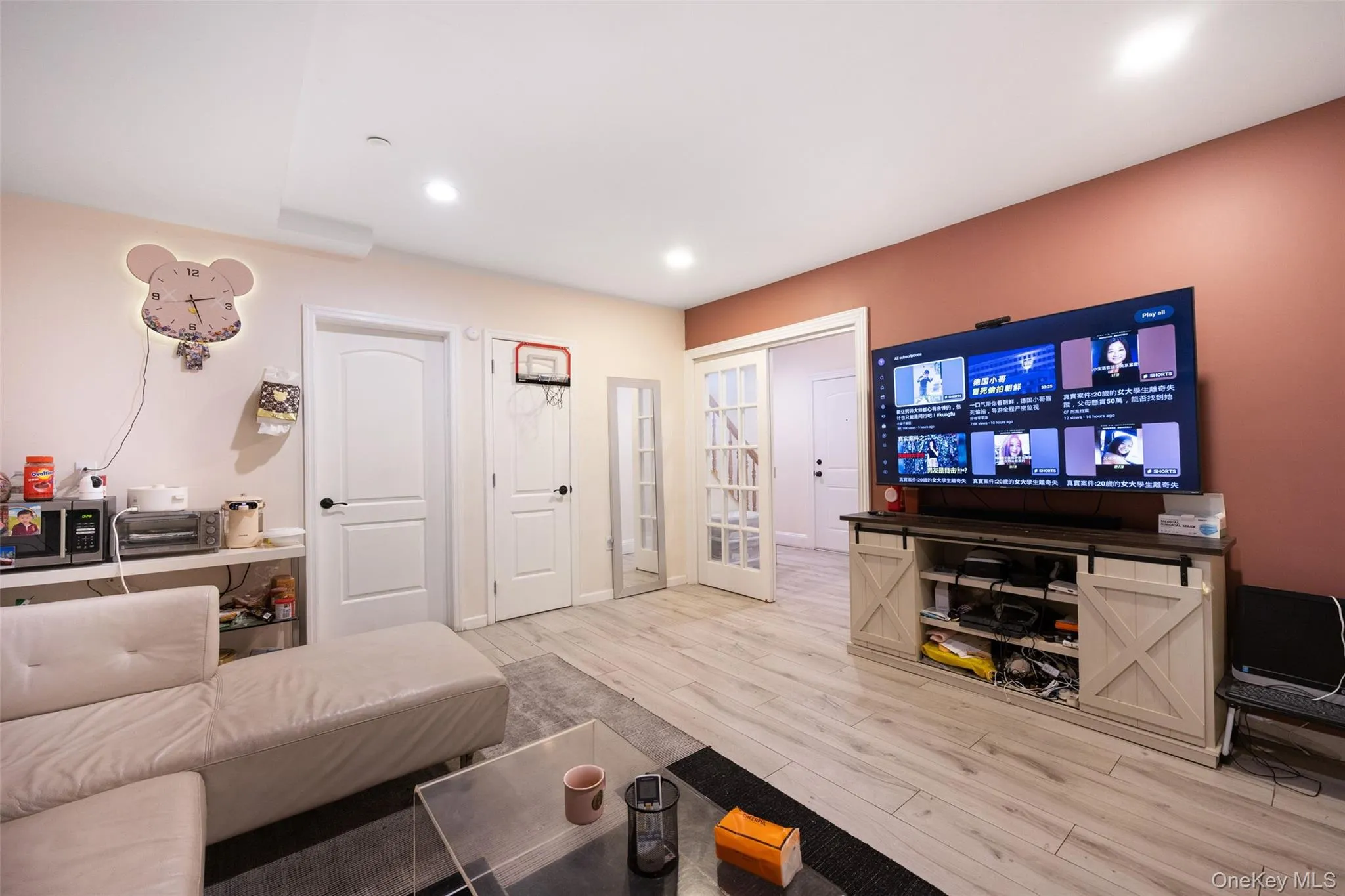 Living room featuring light wood finished floors and recessed lighting Living room featuring light wood finished floors and recessed lighting