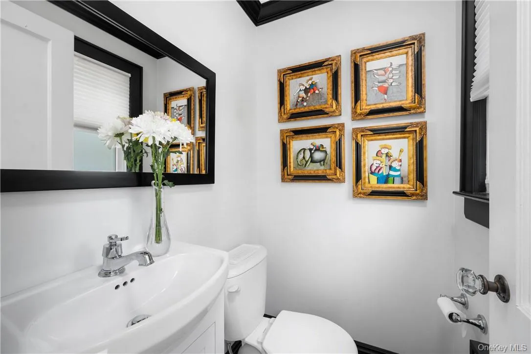 Bathroom featuring toilet and large vanity Bathroom featuring toilet and large vanity