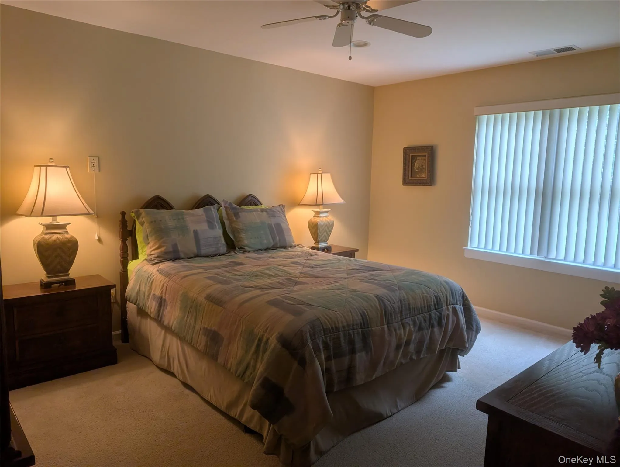 Primary Bedroom featuring a ceiling fan, window with vertical blinds overlooking spacious back yard. Primary Bedroom featuring a ceiling fan, window with vertical blinds overlooking spacious back yard.