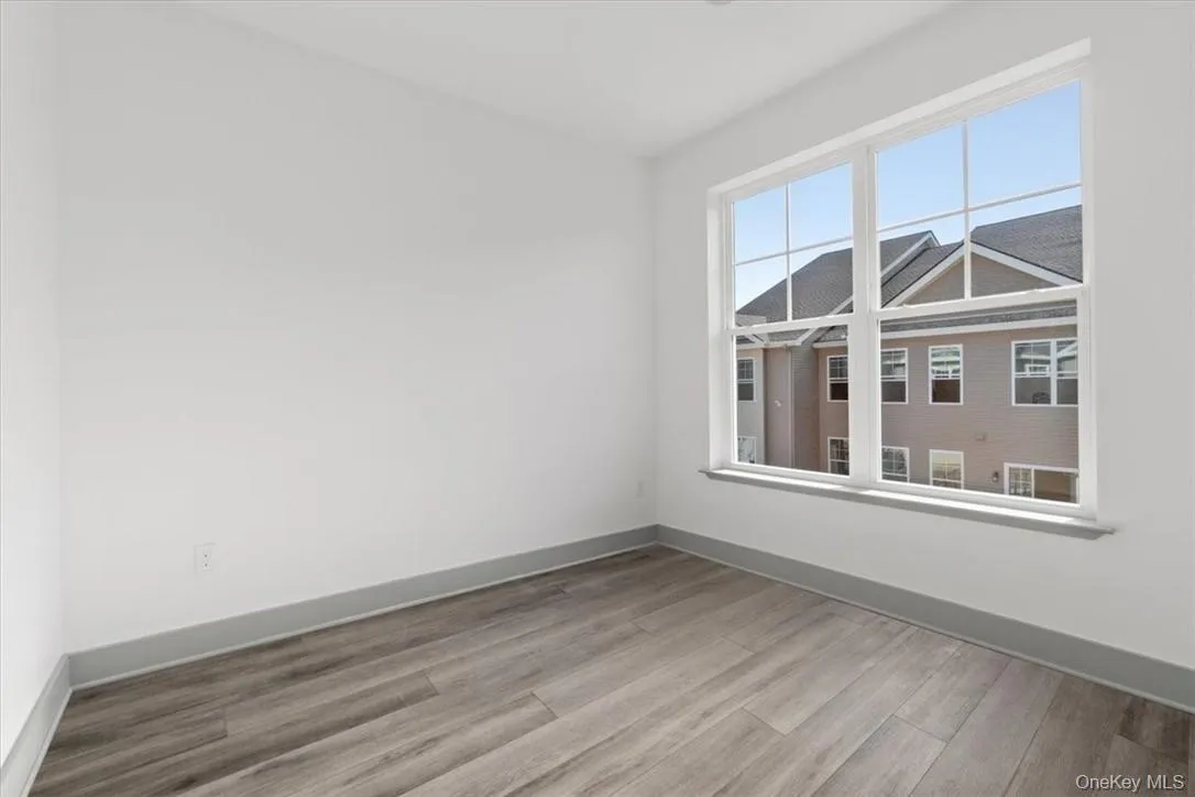 Unfurnished room featuring wood-type flooring Unfurnished room featuring wood-type flooring