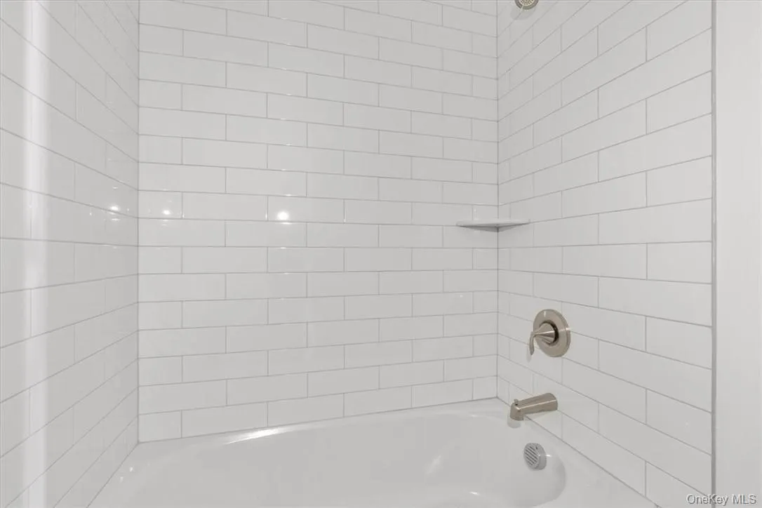 Bathroom featuring tiled shower / bath Bathroom featuring tiled shower / bath