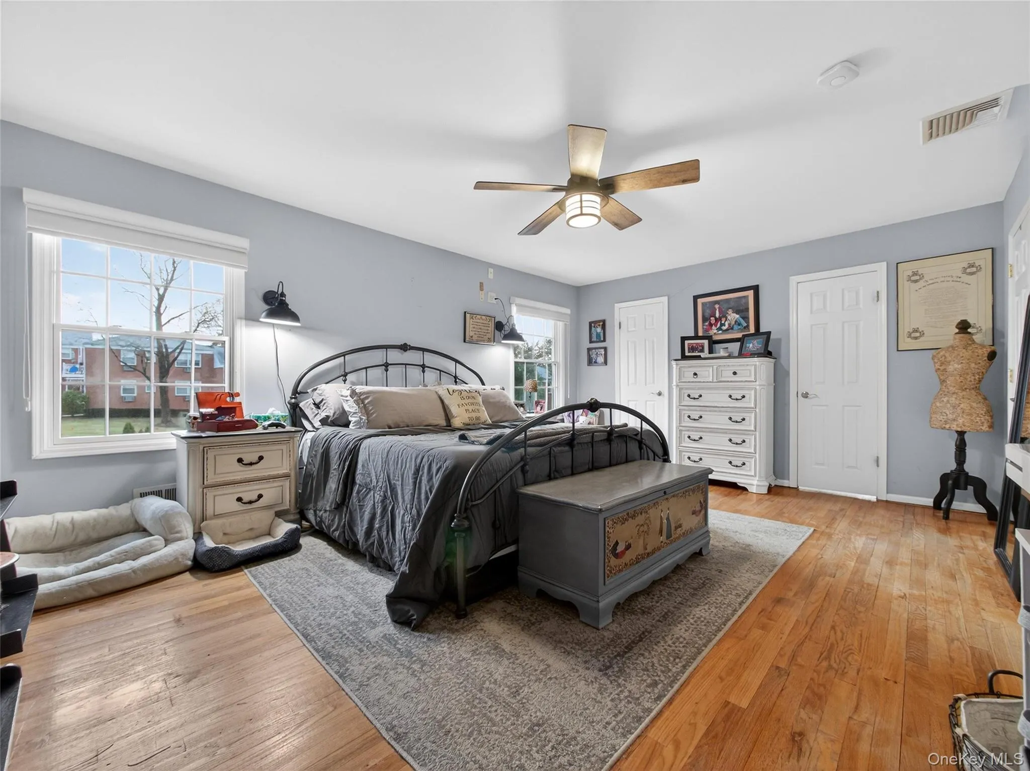 Bedroom with light wood finished floors and a ceiling fan Bedroom with light wood finished floors and a ceiling fan