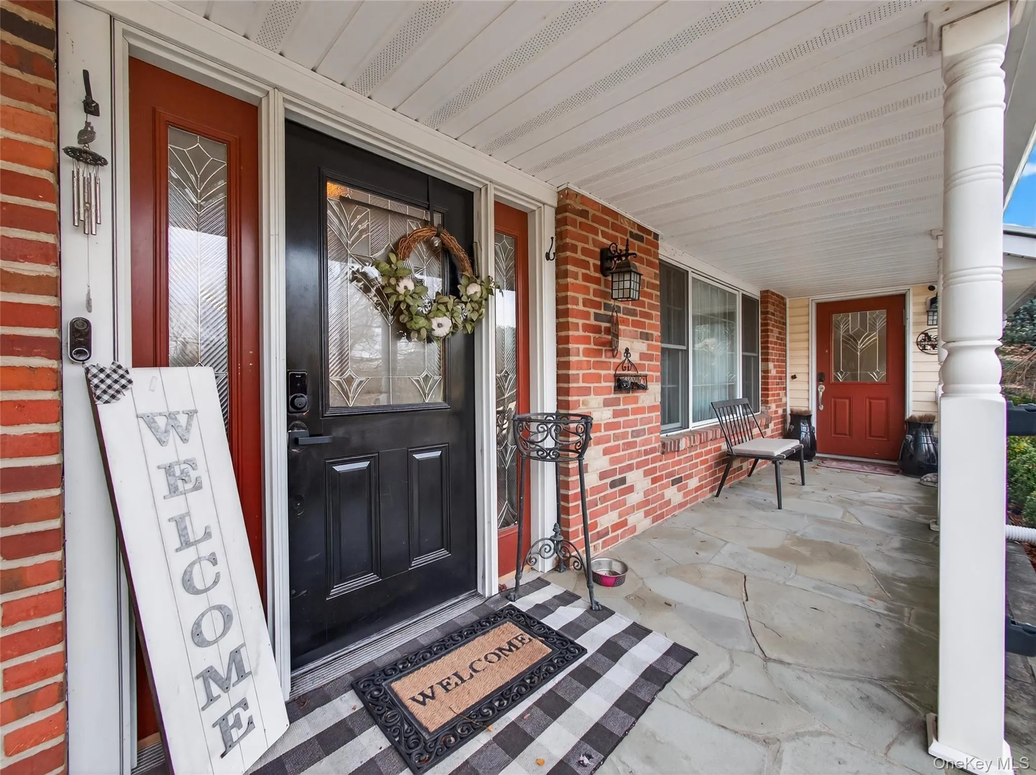 Property entrance featuring a porch and brick siding Property entrance featuring a porch and brick siding