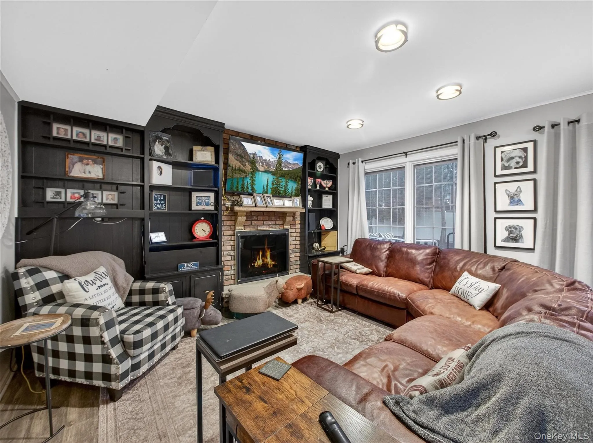 Carpeted living room with a fireplace and built in features Carpeted living room with a fireplace and built in features